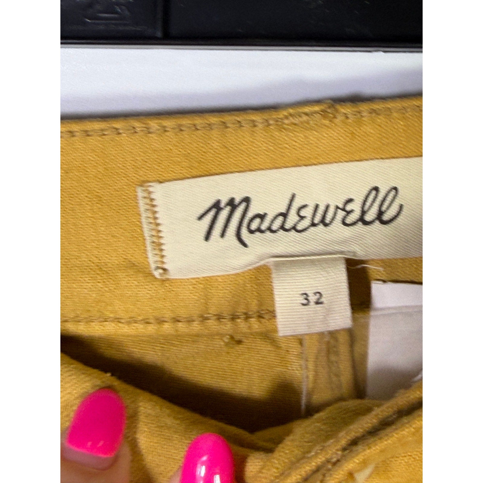Madewell mustard yellow wide-leg crop pants hanging on a rack, showcasing the vintage-inspired design and relaxed fit.