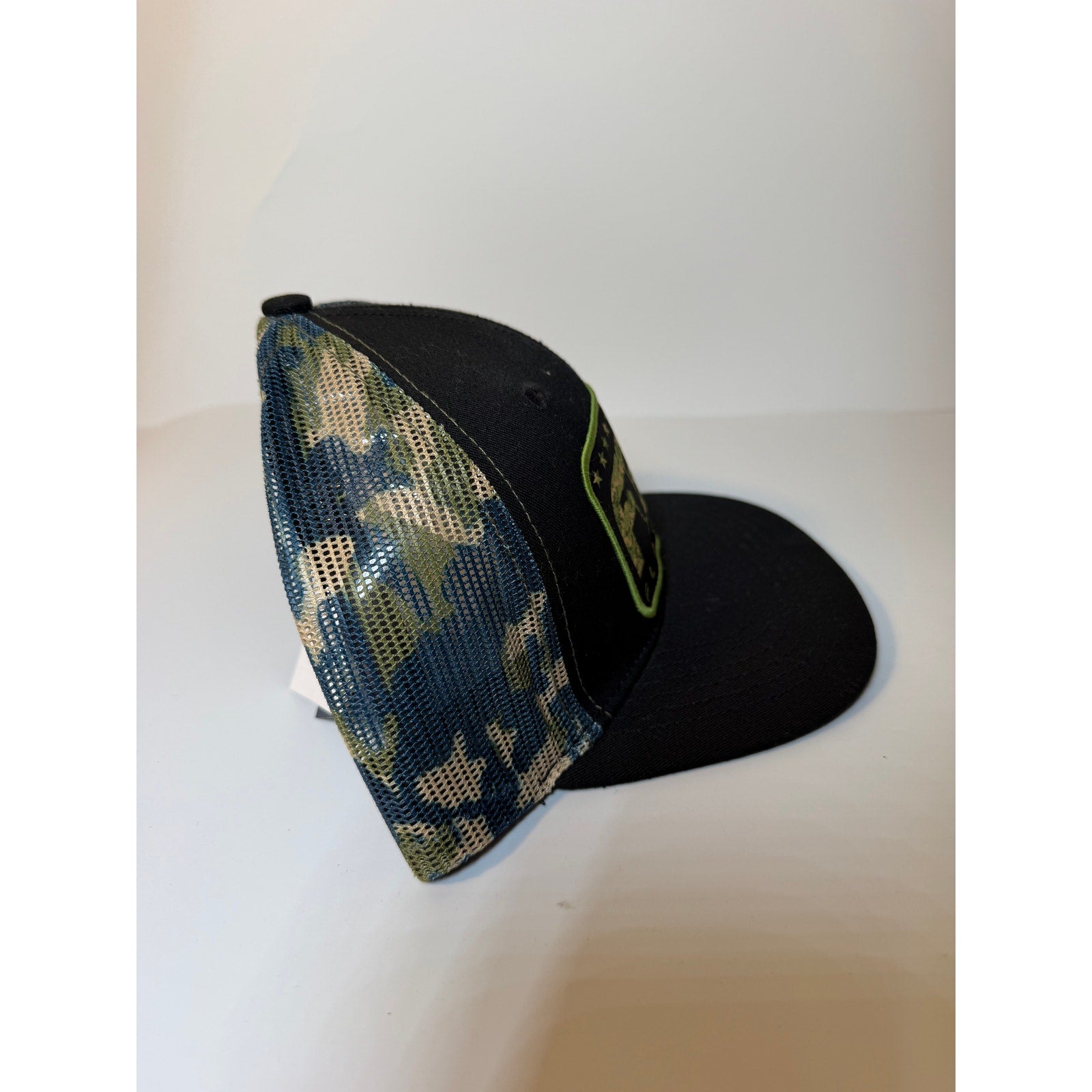 FloGrown Florida flag trucker hat with black camouflage mesh, adjustable snapback cap, featuring Florida-themed design and branding.