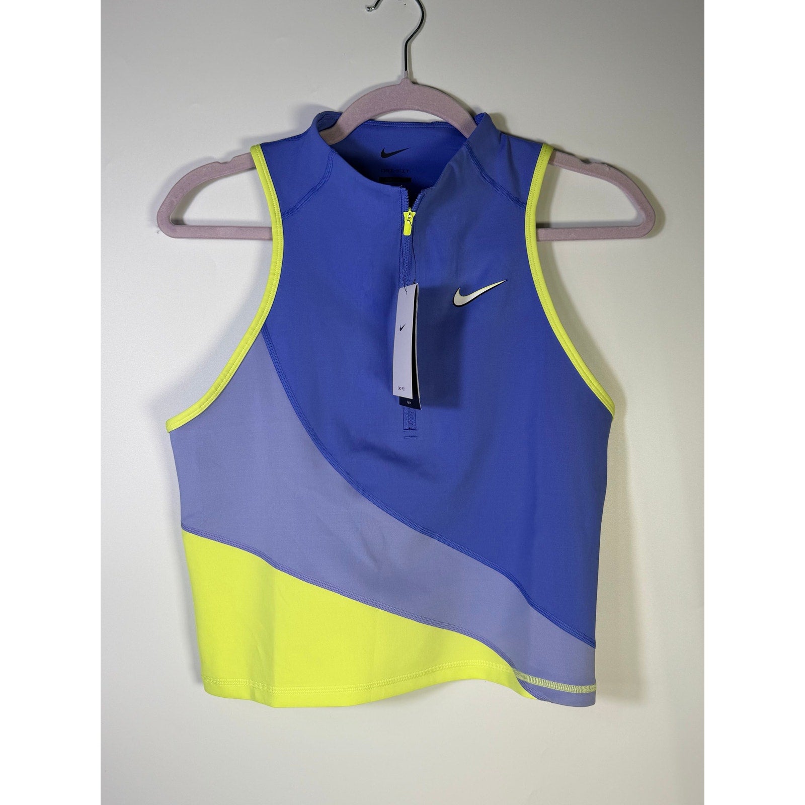 Nike women’s blue and yellow quarter-zip cropped tank top, size L, with Nike logo and breathable fabric.