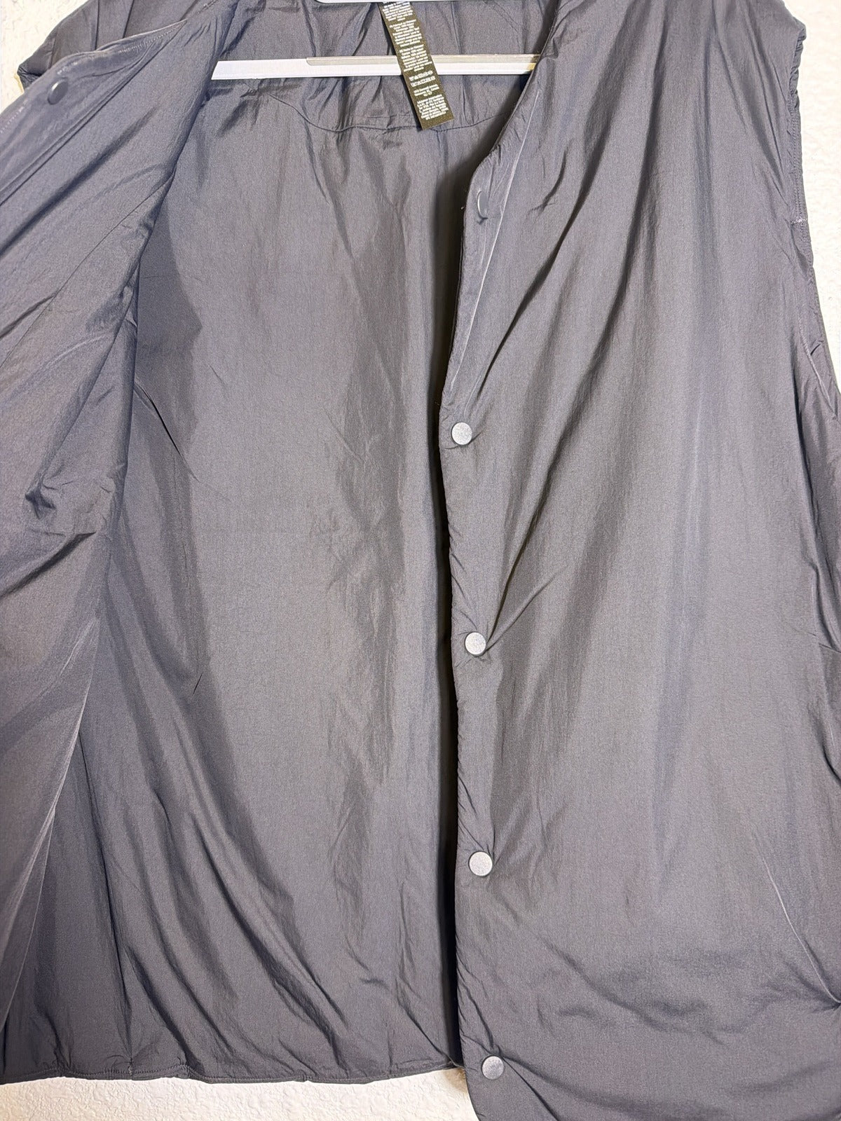 Lululemon Men's ThermoZen insulated vest in black with PrimaLoft insulation and snap front, size XXL, front view.