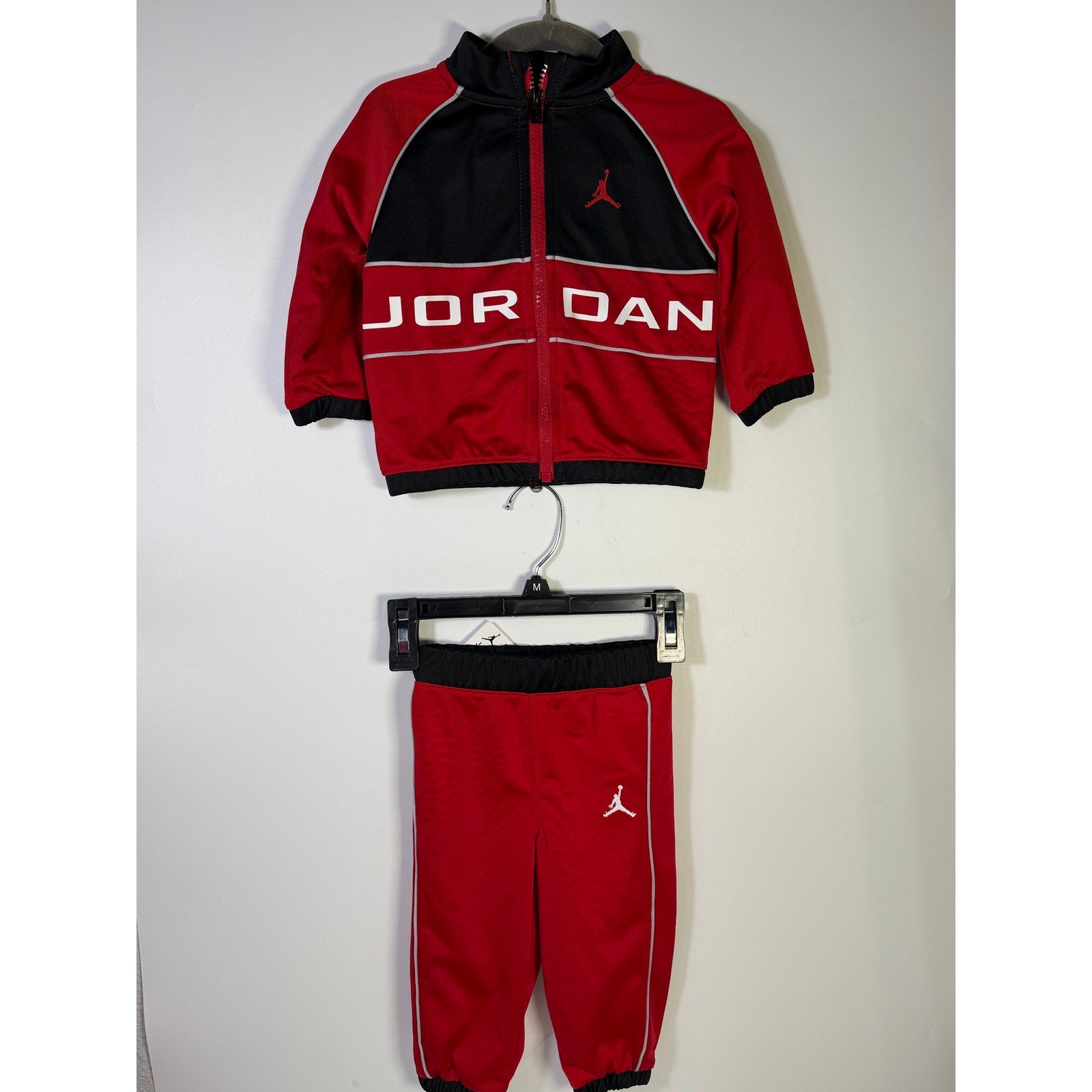 Jordan baby boys 2-piece tracksuit jacket and pants set in red and black, size 12 months, new with tags.