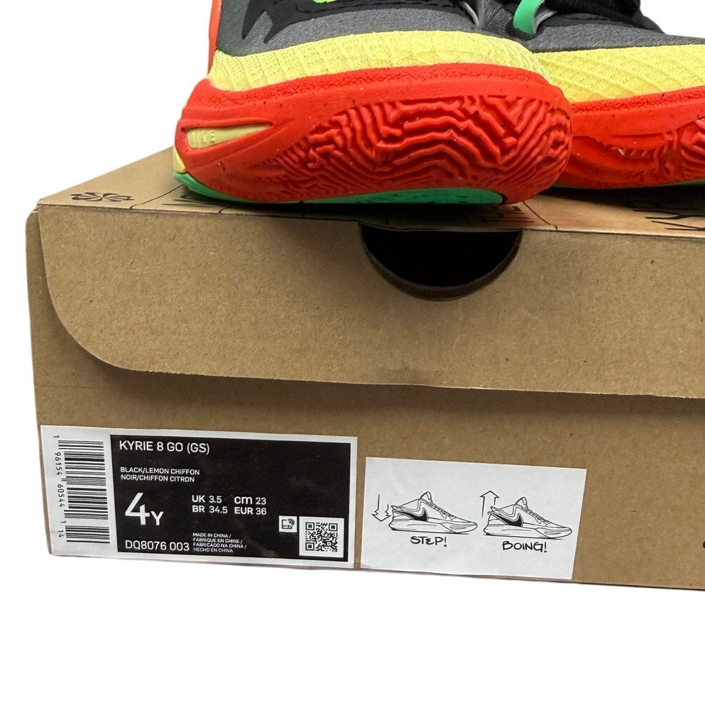Nike Kyrie 8 GO basketball shoes for grade school in black and lemon chiffon, new in box, showing side view and design details.
