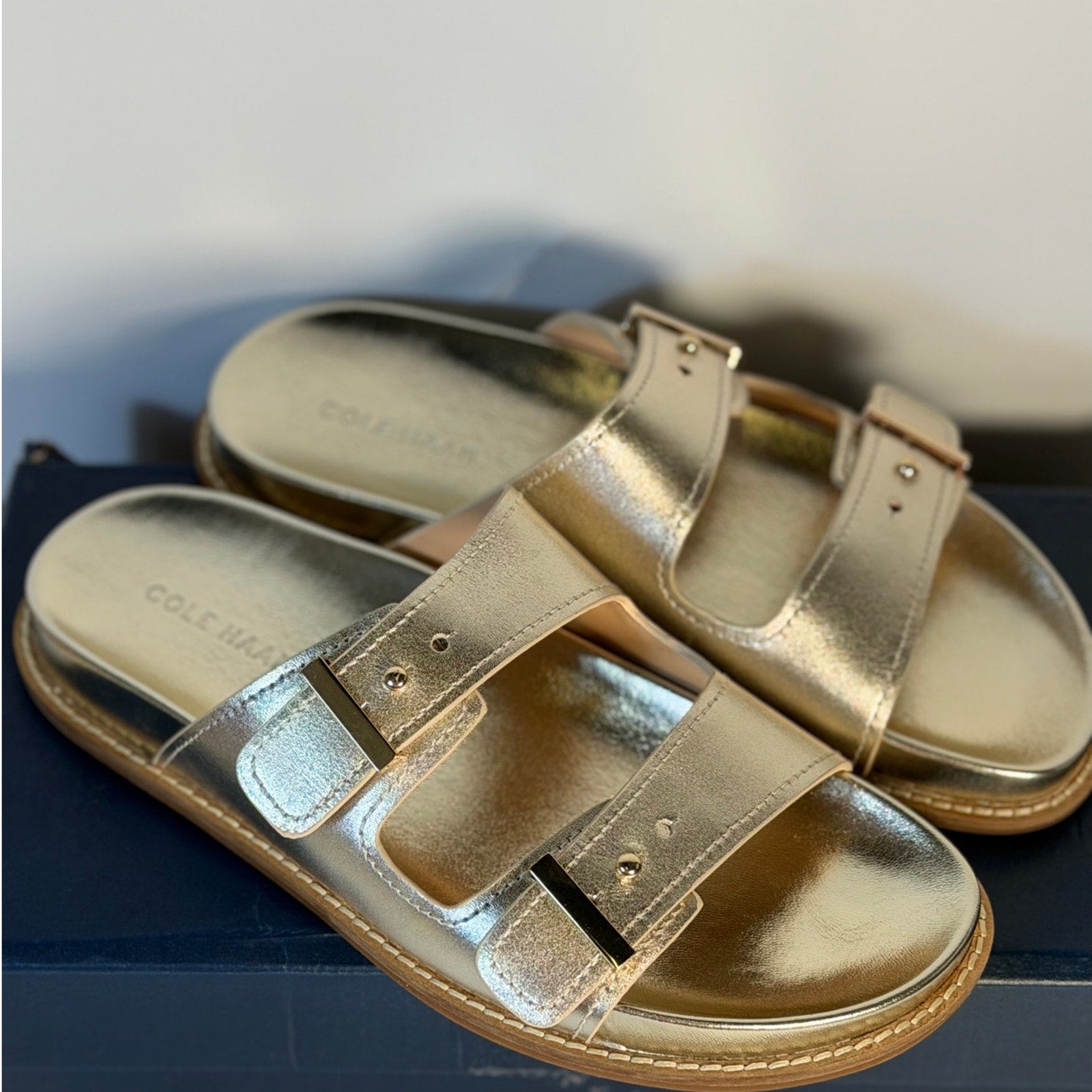 Cole Haan women's gold leather double strap footbed sandals, size 7B, featuring sleek straps and cushioned footbed.