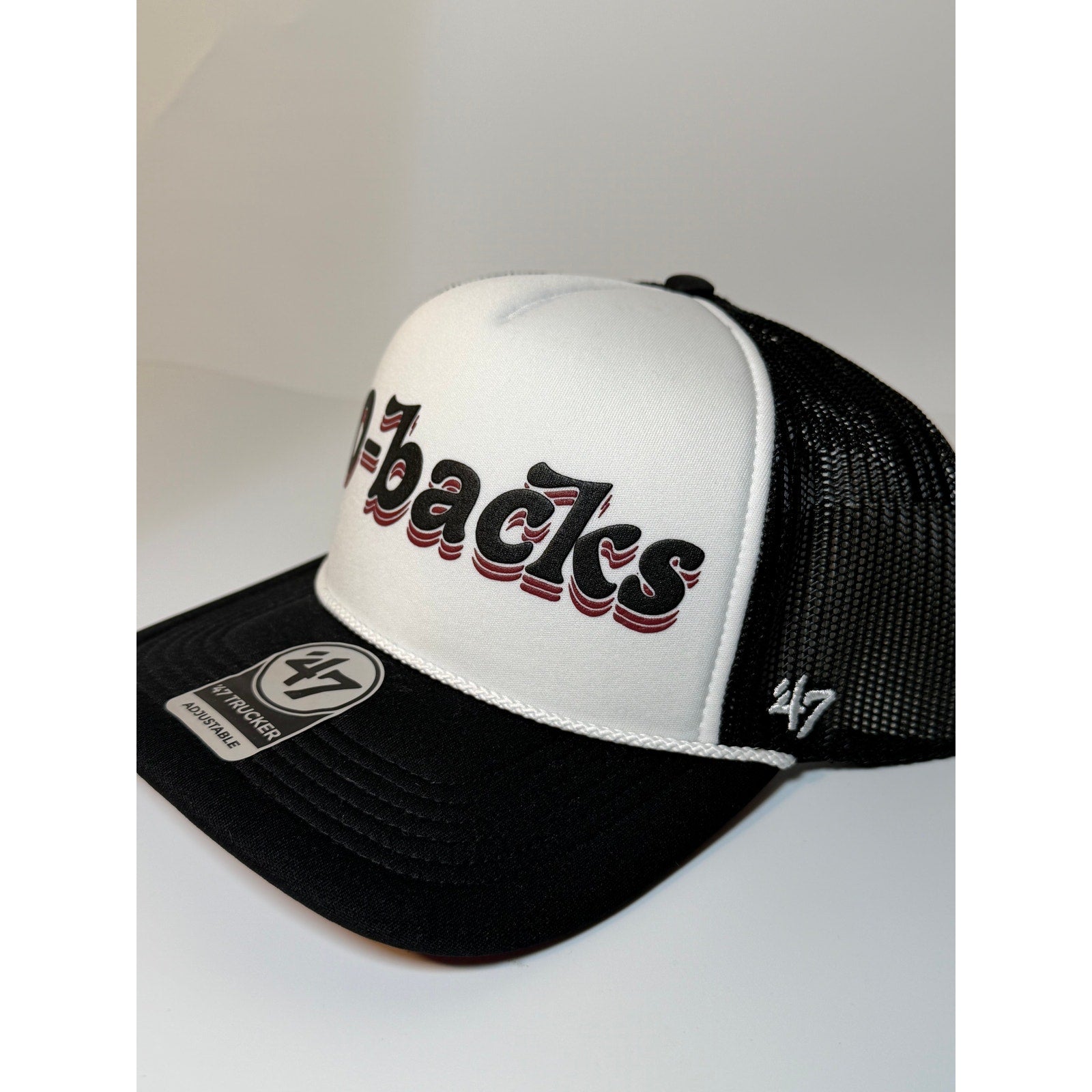 Black and white 47 Brand Arizona Diamondbacks trucker hat with adjustable strap and team logo, front view.