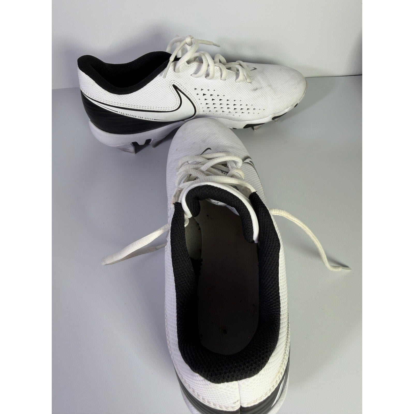 Nike Vapor football cleats in white and black, men's size 8.5 US, featuring a sleek design and durable studded sole.