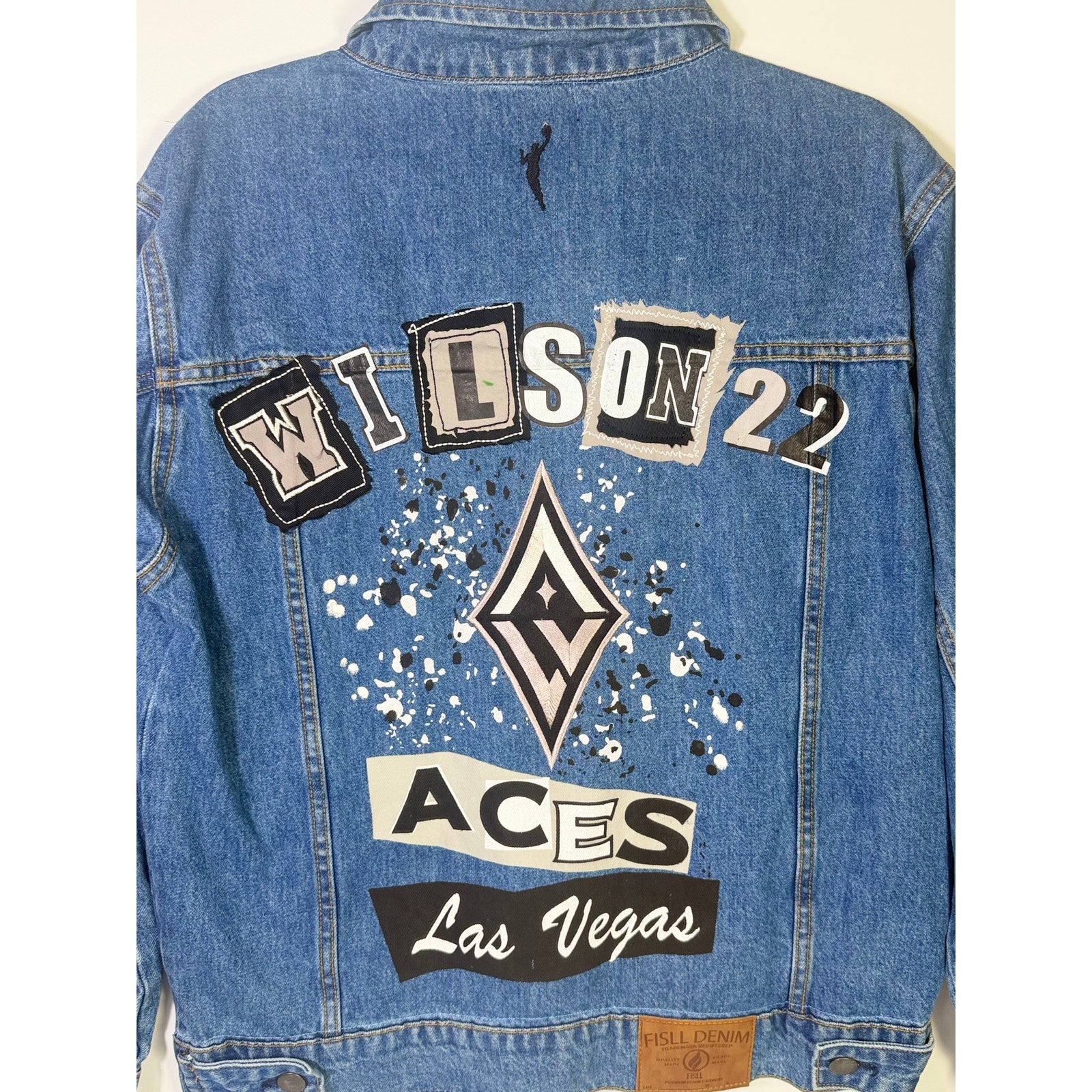 FISLL Las Vegas Aces Wilson #22 denim jacket, unisex medium size, featuring team logo and classic blue denim fabric.