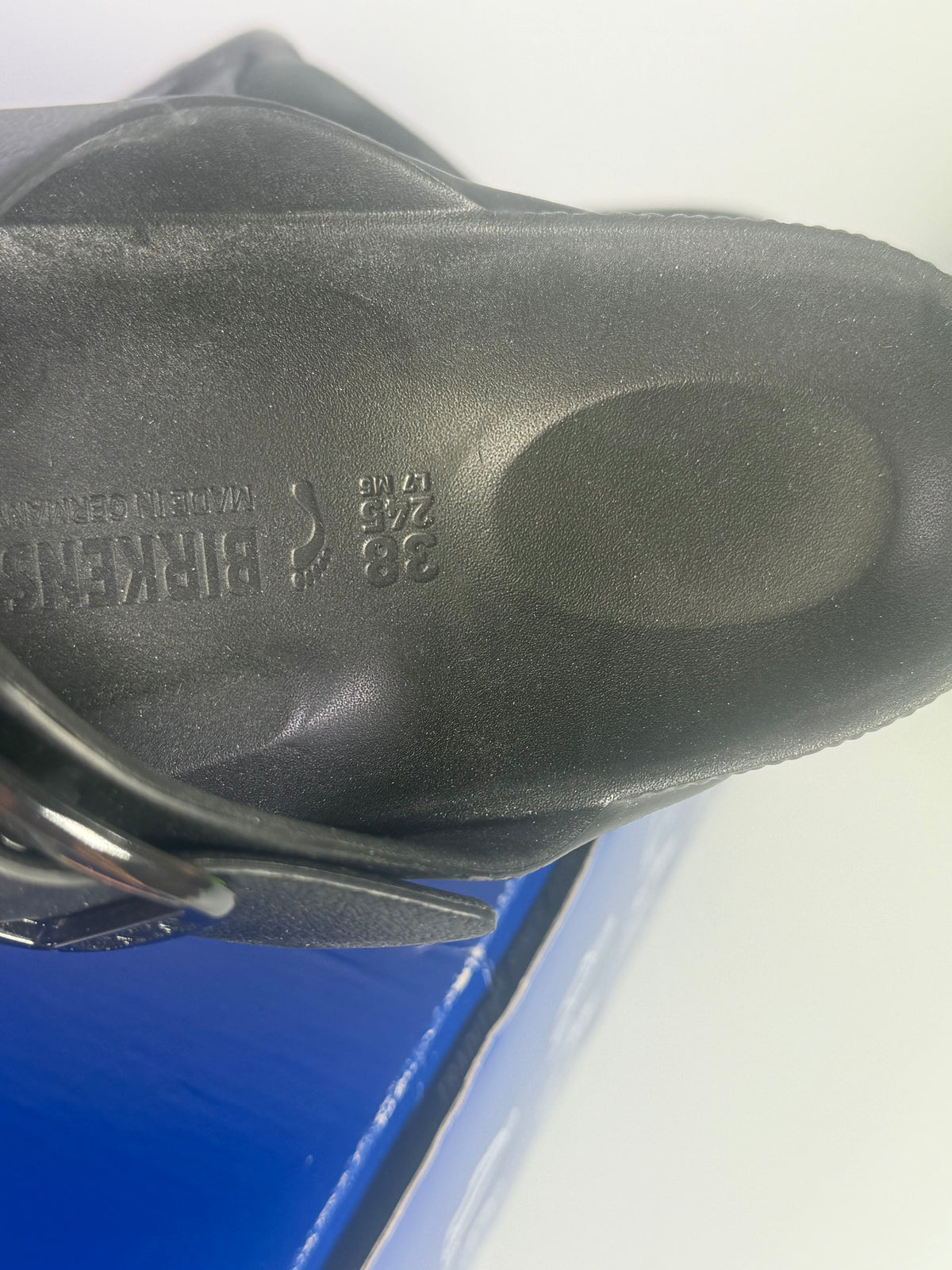 Black Birkenstock Arizona EVA sandals with big buckle, narrow fit, and open-toe design for women in US size 7.