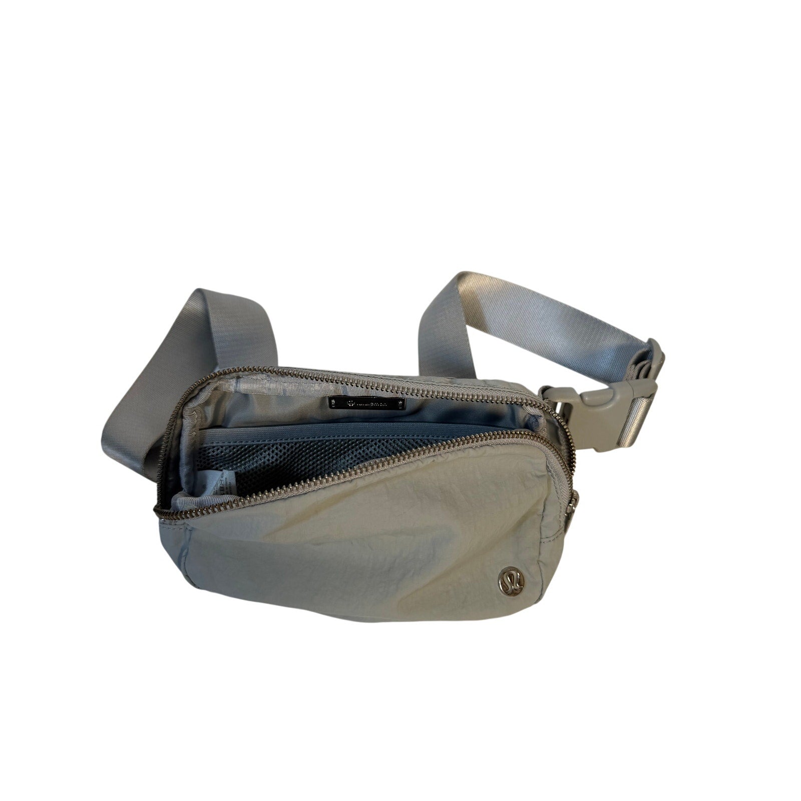 Light gray Lululemon Everywhere Belt Bag, a versatile crossbody waist pack with a sleek handbag design.
