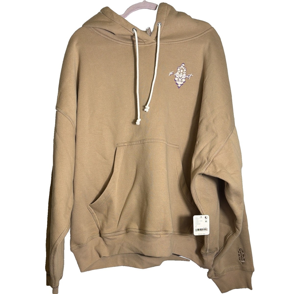 Sand-colored Free People FP Movement graphic hoodie for women, shown in a close-up of the sweatshirt's front design.