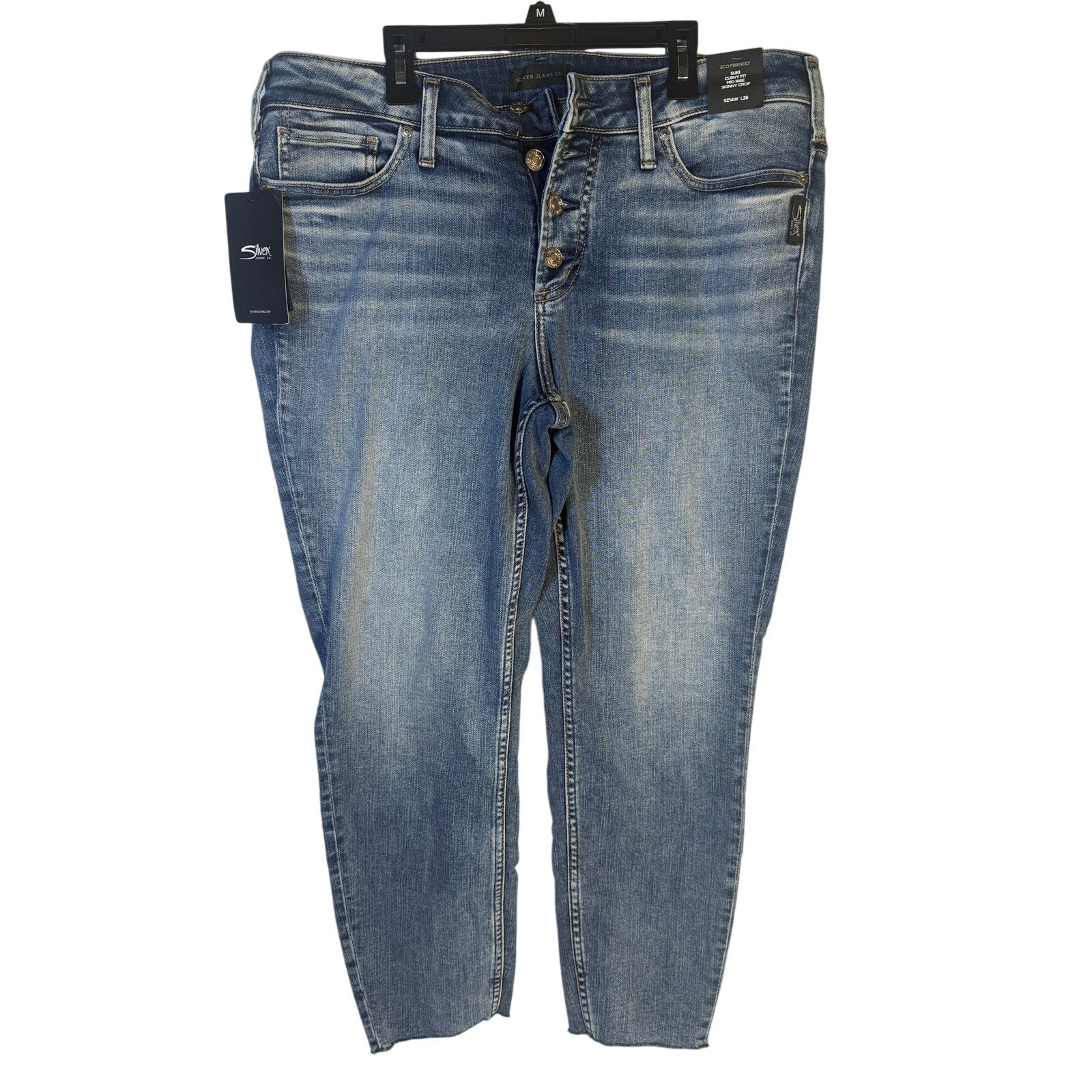 Silver Jeans Co. Suki curvy fit mid-rise skinny crop jeans for women, size 14W, displayed on a hanger.