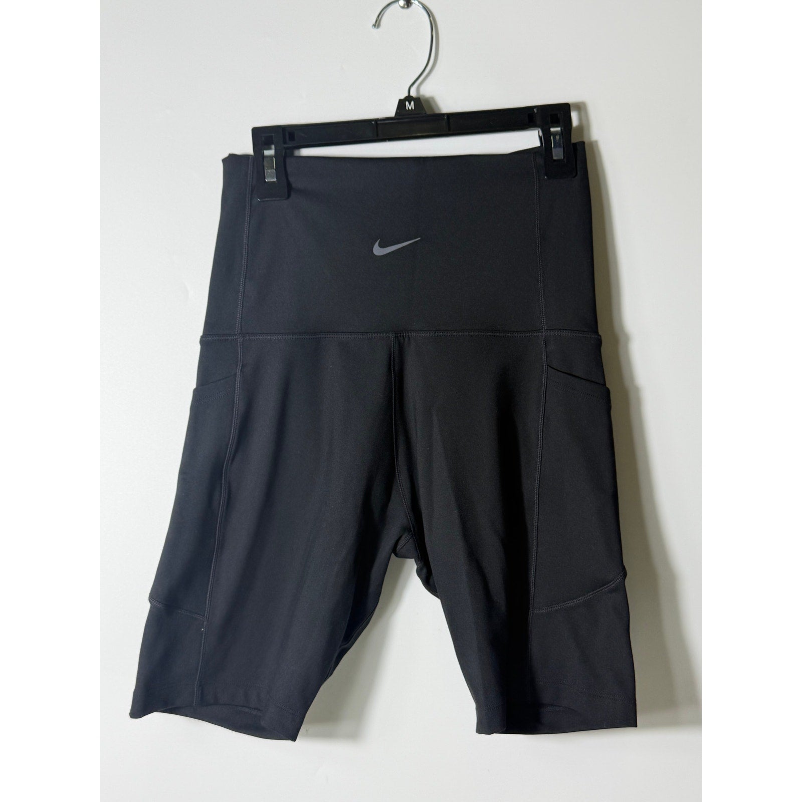 Nike women's black high-waisted training bike shorts, small size, close-up view of the fitted athletic shorts.