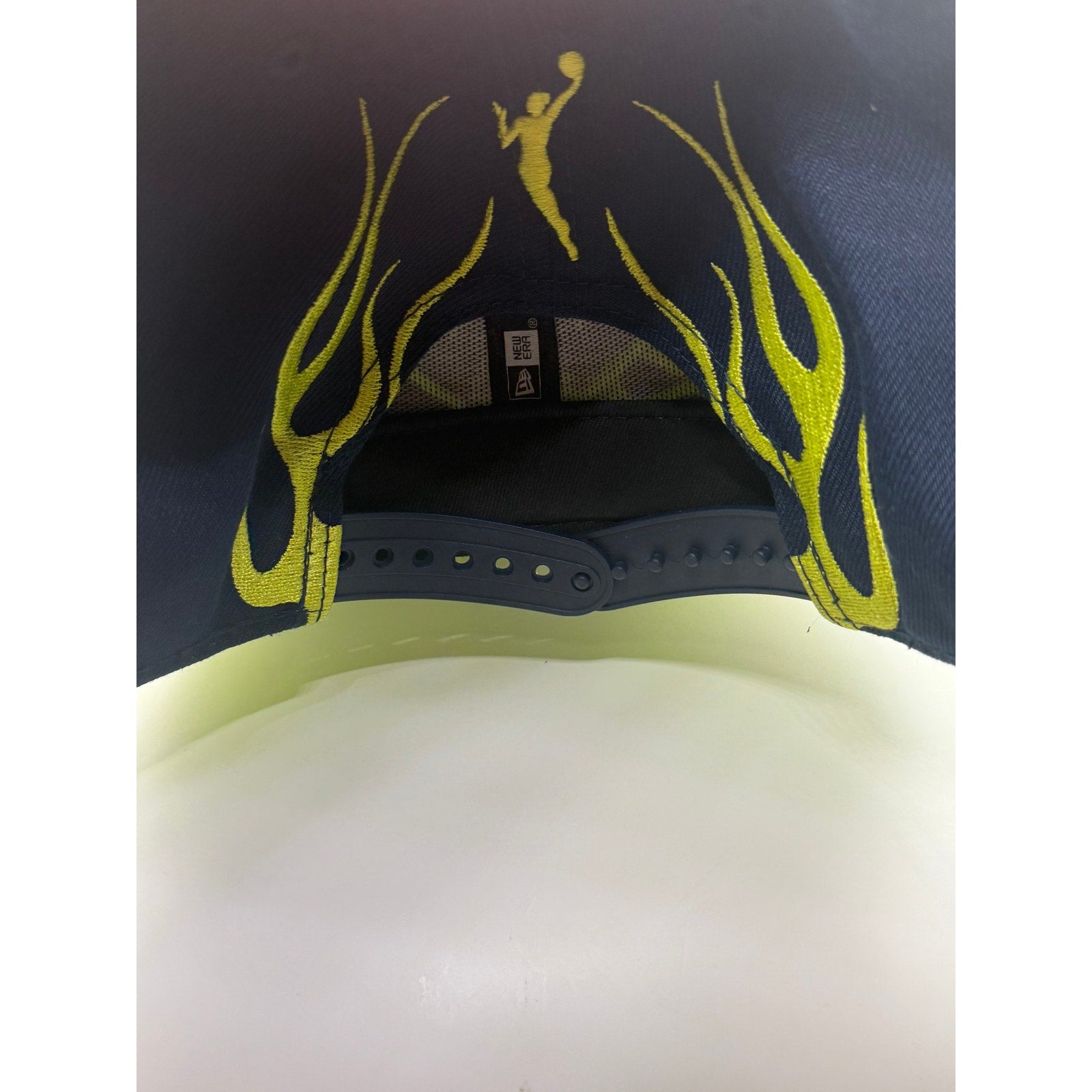 New Era Dallas Wings WNBA snapback hat in navy with neon yellow flame brim, one size adjustable, stylish sports headwear