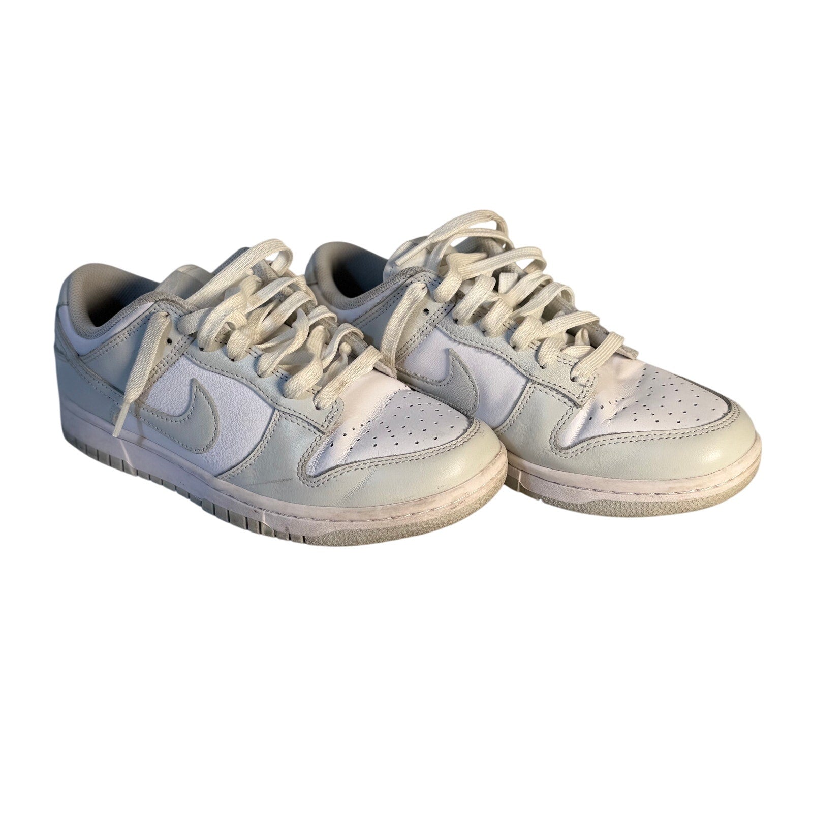 Nike Dunk Low Triple White sneakers for men, casual white leather shoes in size 7.5, displayed from a front angle.