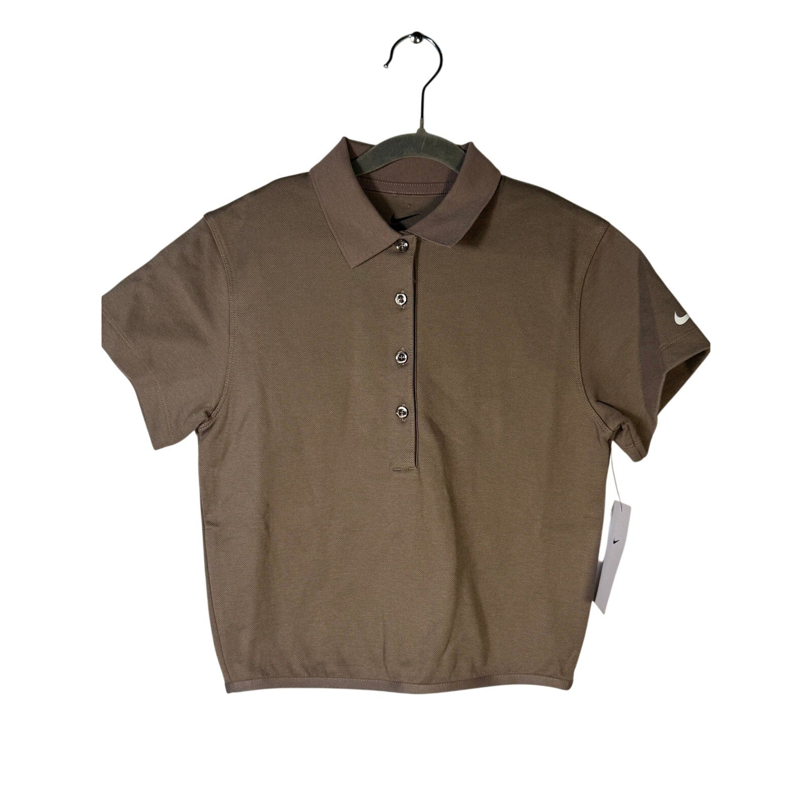 Nike women's short-sleeve golf polo in mink brown, size XS, shown on a hanger with a collared design and Nike logo.