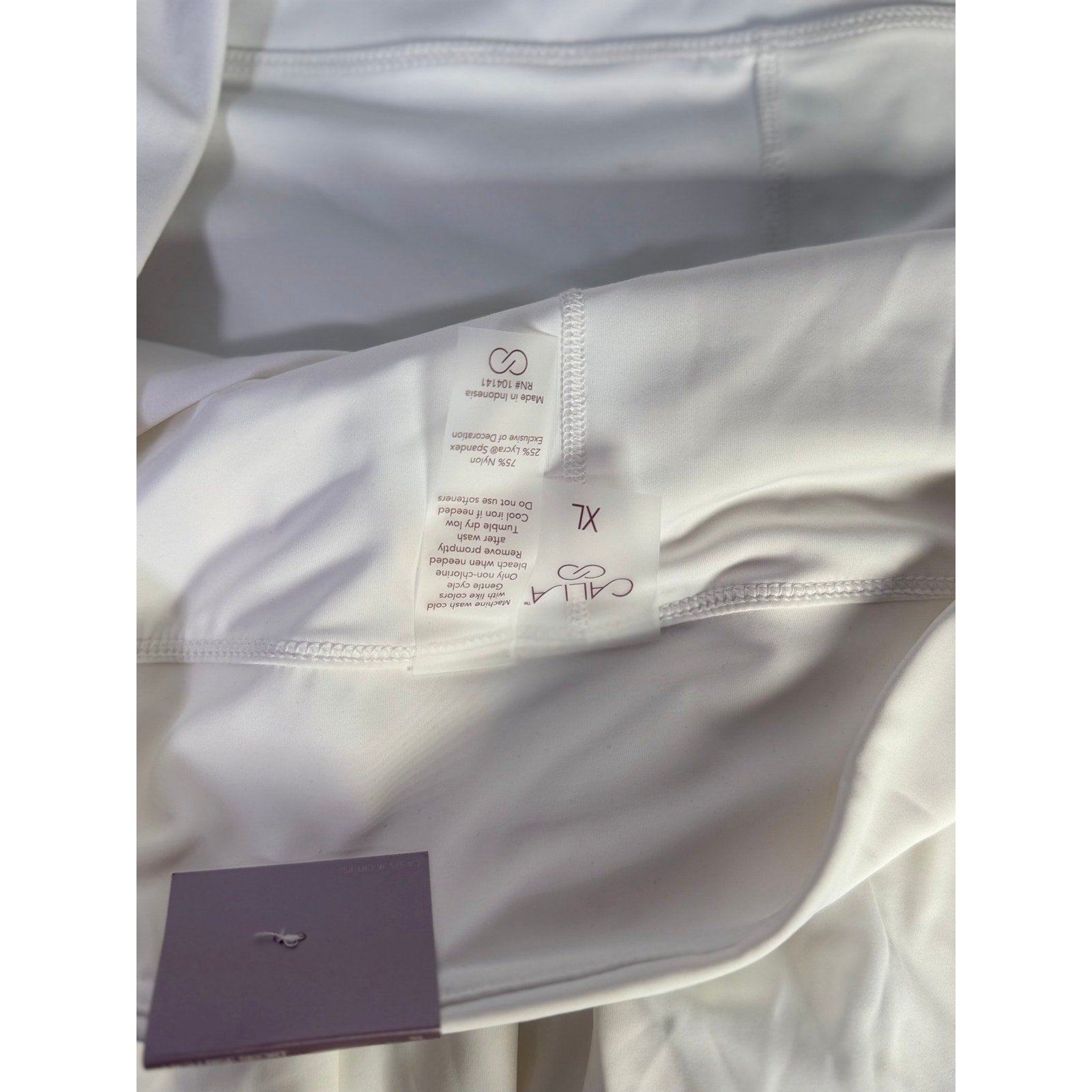 White CALIA Women’s Court Collection high-rise skort, 14-inch length, size XL, with athletic design and built-in shorts.