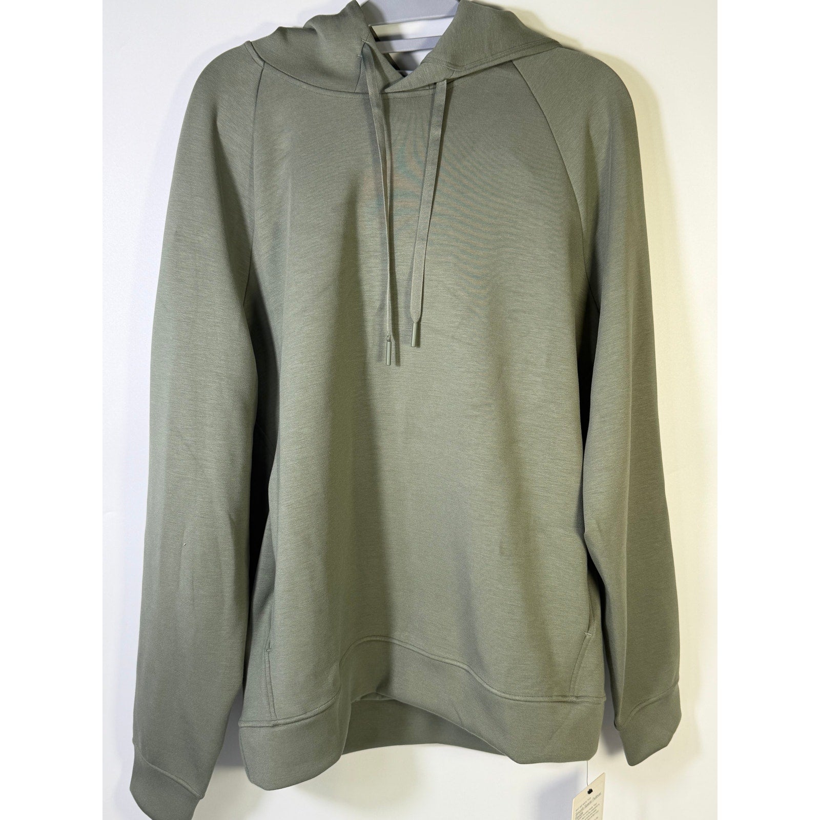 Men's green Lululemon Smooth Spacer Pullover Hoodie, size medium, shown on a mannequin with a relaxed fit and soft fabric texture.