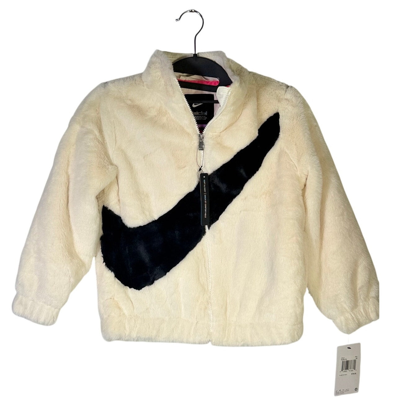 Nike girls' faux fur full zip jacket in cream and black, size 6X, featuring an oversized swoosh logo, new with tags.