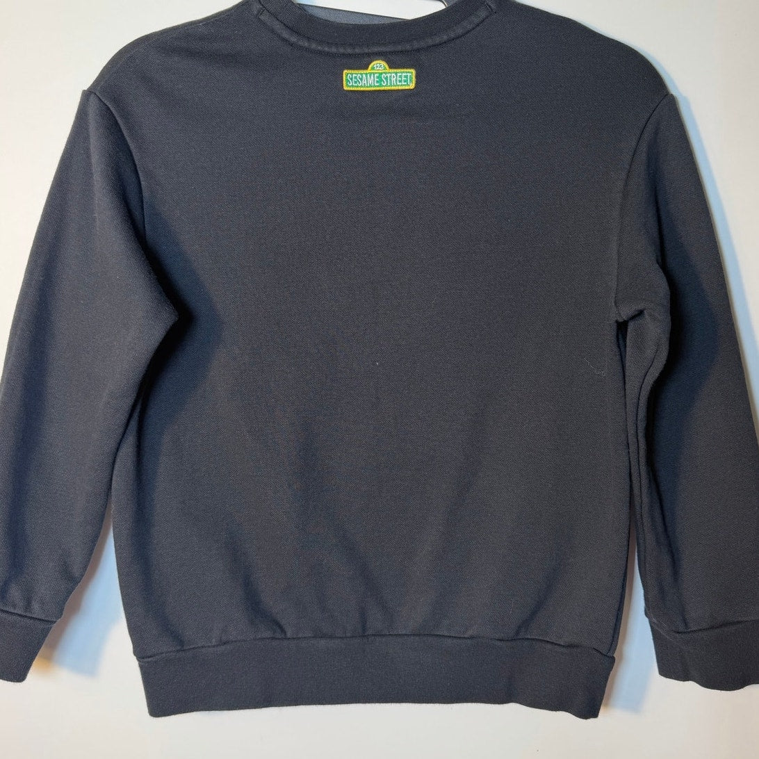 Under Armour Curry Sesame Street youth medium black crewneck sweatshirt with colorful Sesame Street character graphics.