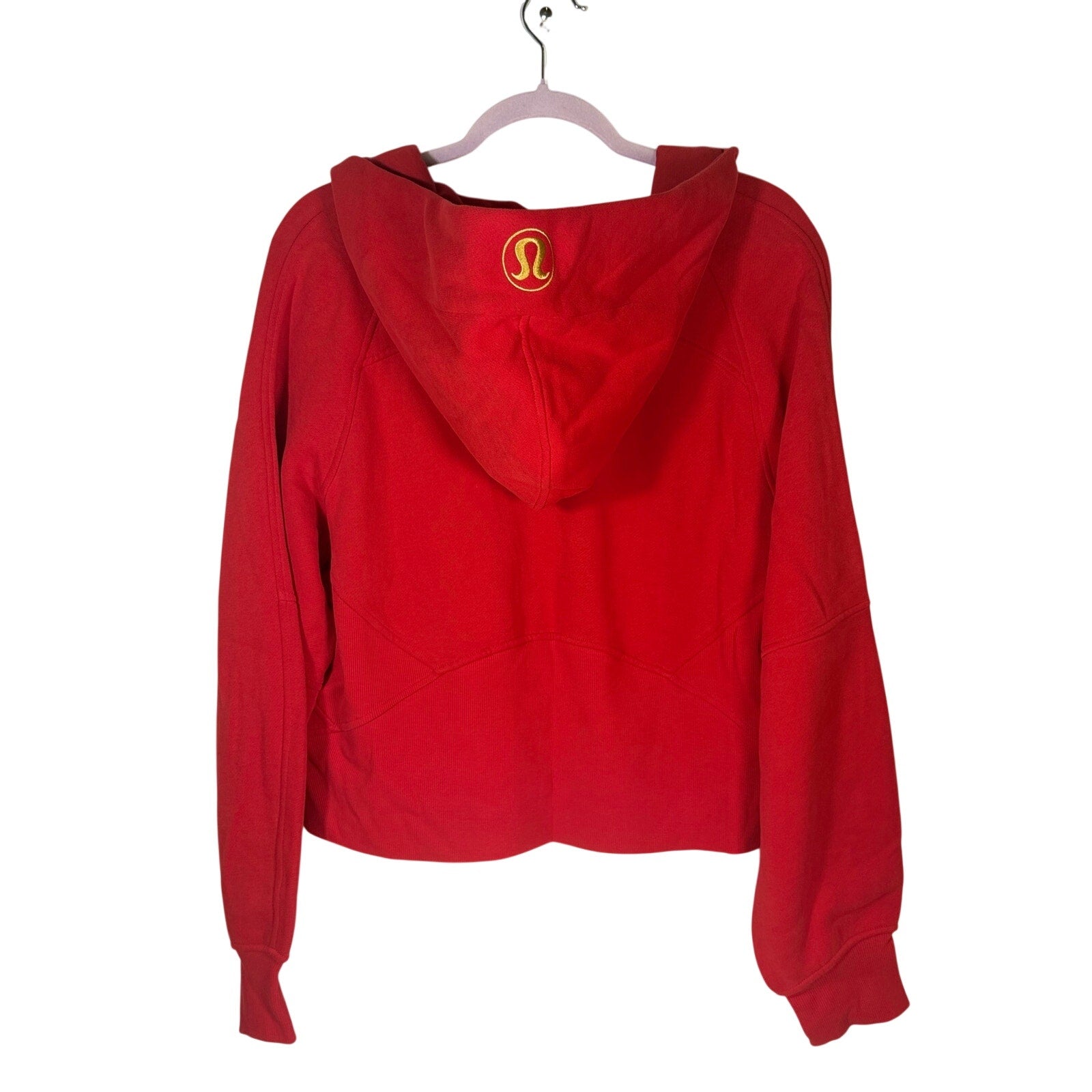 Lululemon women's red scuba oversized full-zip hoodie, gold accents, size M/L, displayed on a hanger.