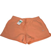 Nike women’s peach orange fleece drawstring shorts in size XL with elastic waistband and relaxed fit.