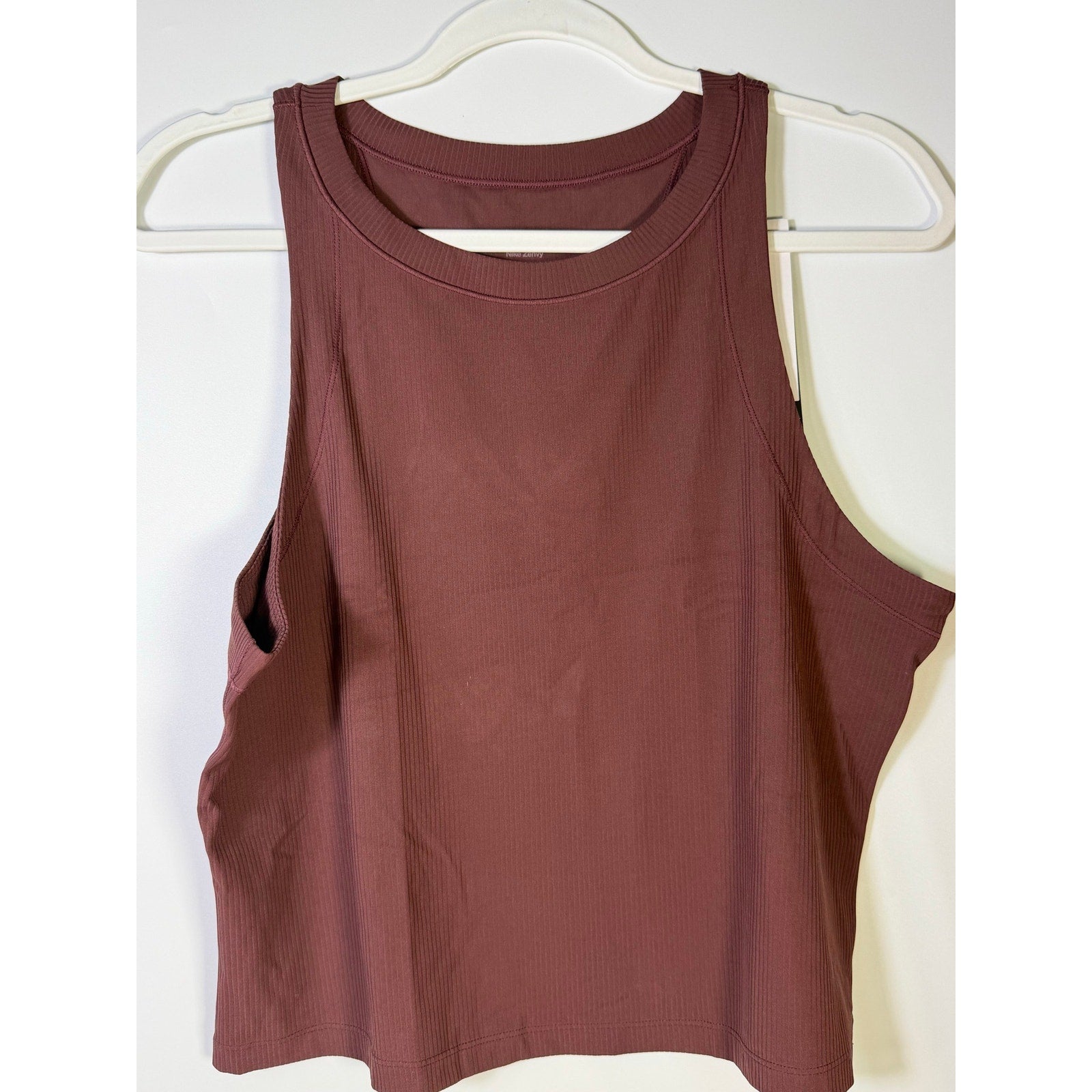 Nike women's brown ribbed cropped muscle tank top, size L, showing front view with sleeveless design and fitted style.
