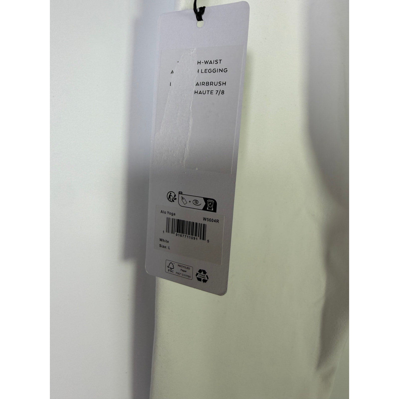Alo Yoga 7/8 high waist airbrush leggings in white, women's size large, displayed on a model highlighting the fitted design.