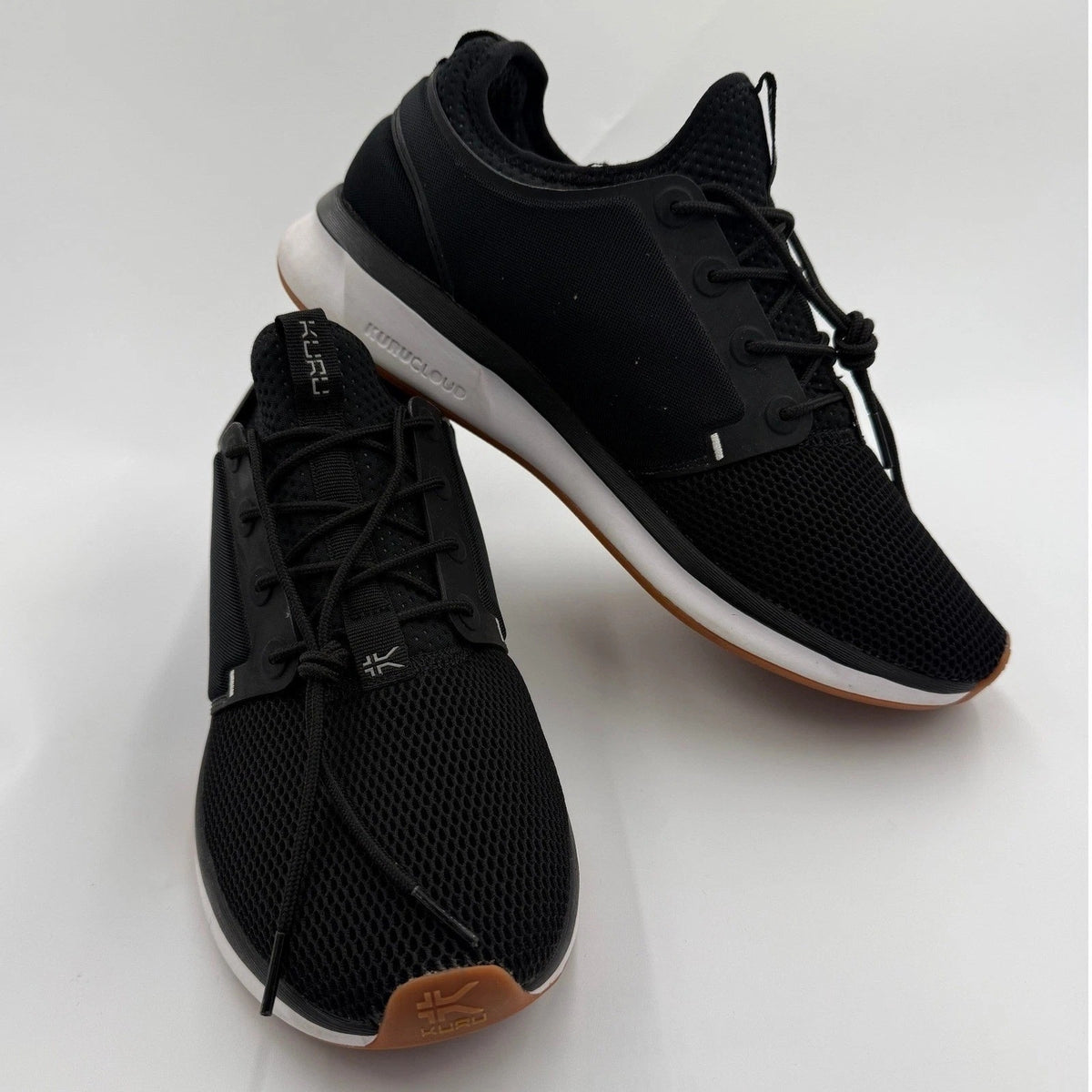 KURU ATOM Women's 12 medium jet black and white gum supportive walking sneakers with cushioned soles and sporty design.