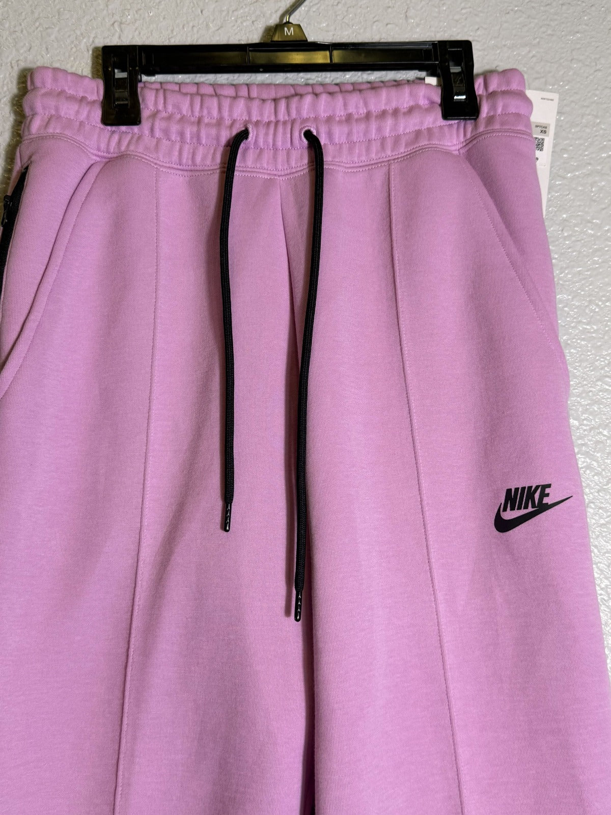 Pink Nike Sportswear Tech Fleece Joggers for women, size XS, mid-rise, soft fleece fabric, casual athletic pants.