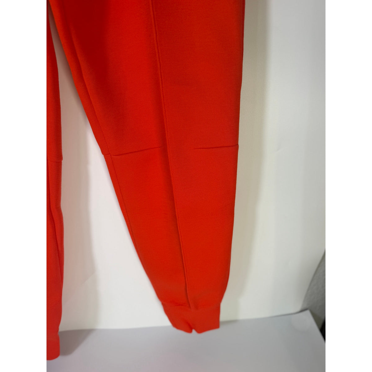 Nike Sportswear Phoenix fleece jogger pants in bright orange, women's XS, mid-rise with relaxed fit and elastic cuffs.