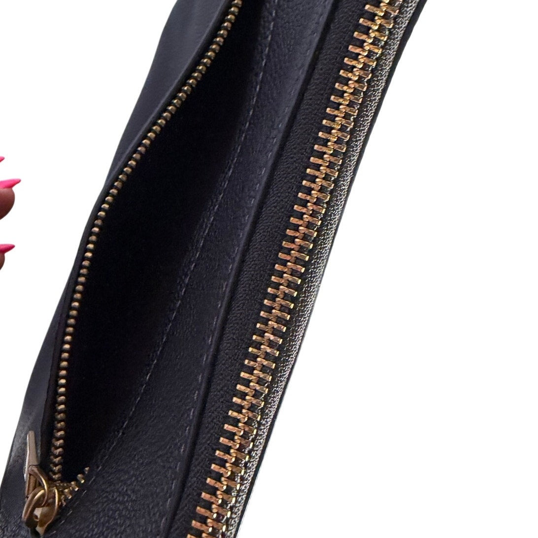 Coach women's black pebbled leather crossbody handbag with gold-tone hardware, shoulder strap, and compact design.