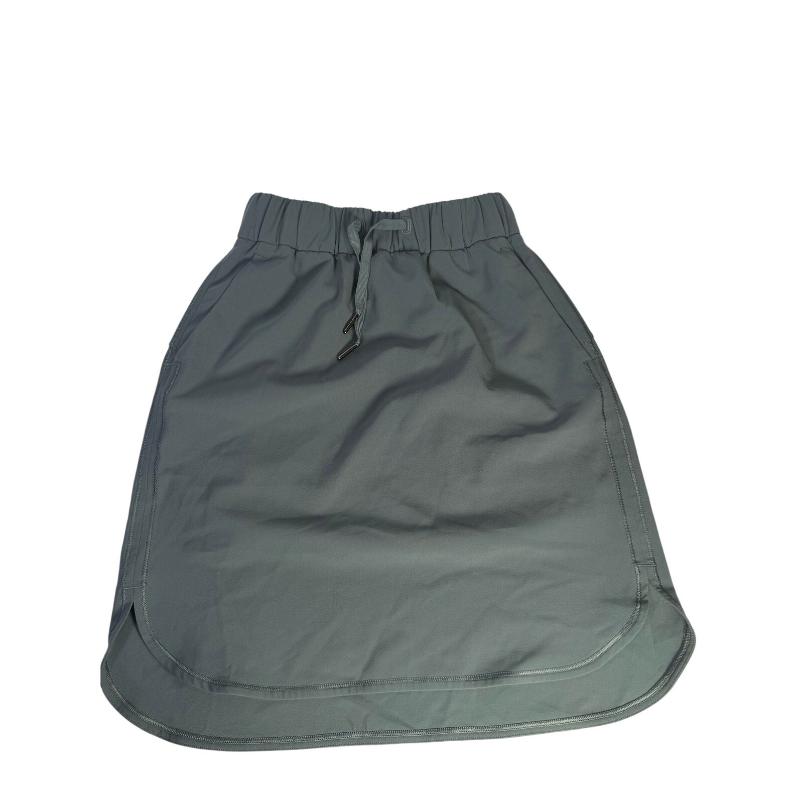Lululemon women's sage gray pull-on athletic skirt, size 2, made of lightweight, stretchy fabric for active wear.