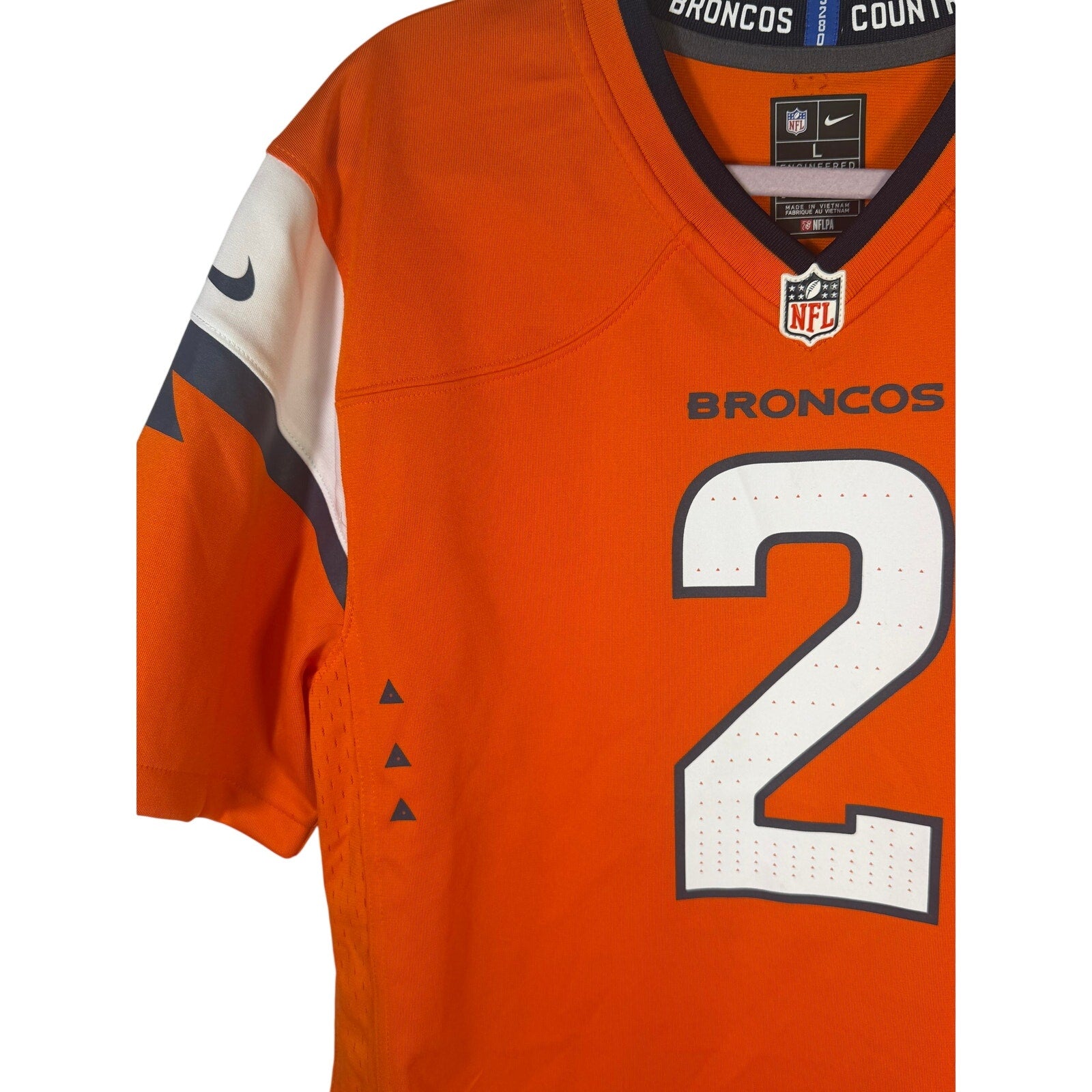 Nike youth Denver Broncos Patrick Surtain II #2 game jersey in orange, size L, featuring team logo and player name.