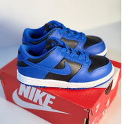 Nike Dunk Low GS sneakers for kids in royal blue and black with athletic design and Nike branding, perfect for active wear.