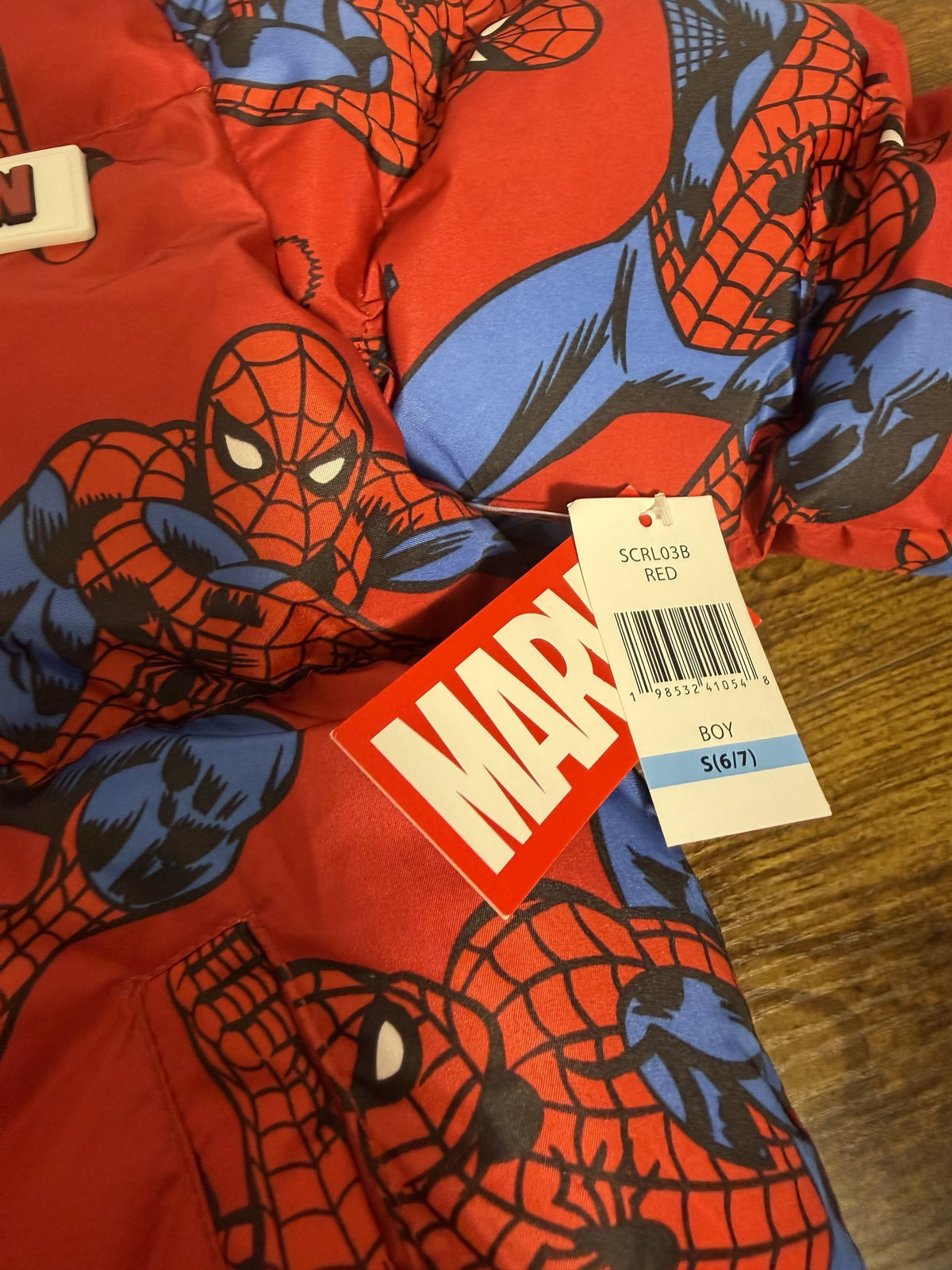 Red Marvel Spider-Man hooded puffer jacket for boys size 6/7, sherpa-lined, featuring Spider-Man graphics and a cozy winter design.
