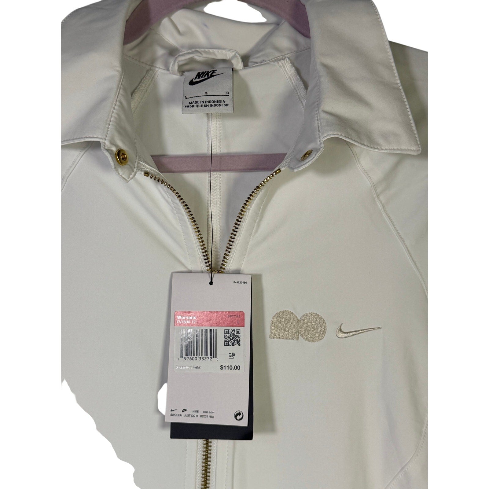 Nike women's long full zip jacket in cream with logo, size XL, displayed on a hanger.