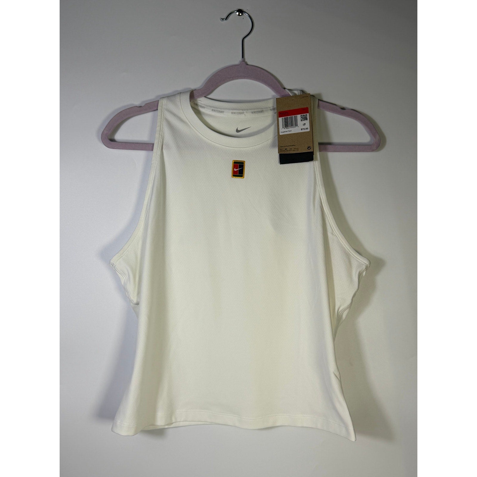 NikeCourt women's white Dri-FIT tennis tank top, size large, shown on a hanger with a fitted athletic design and sleeveless style.