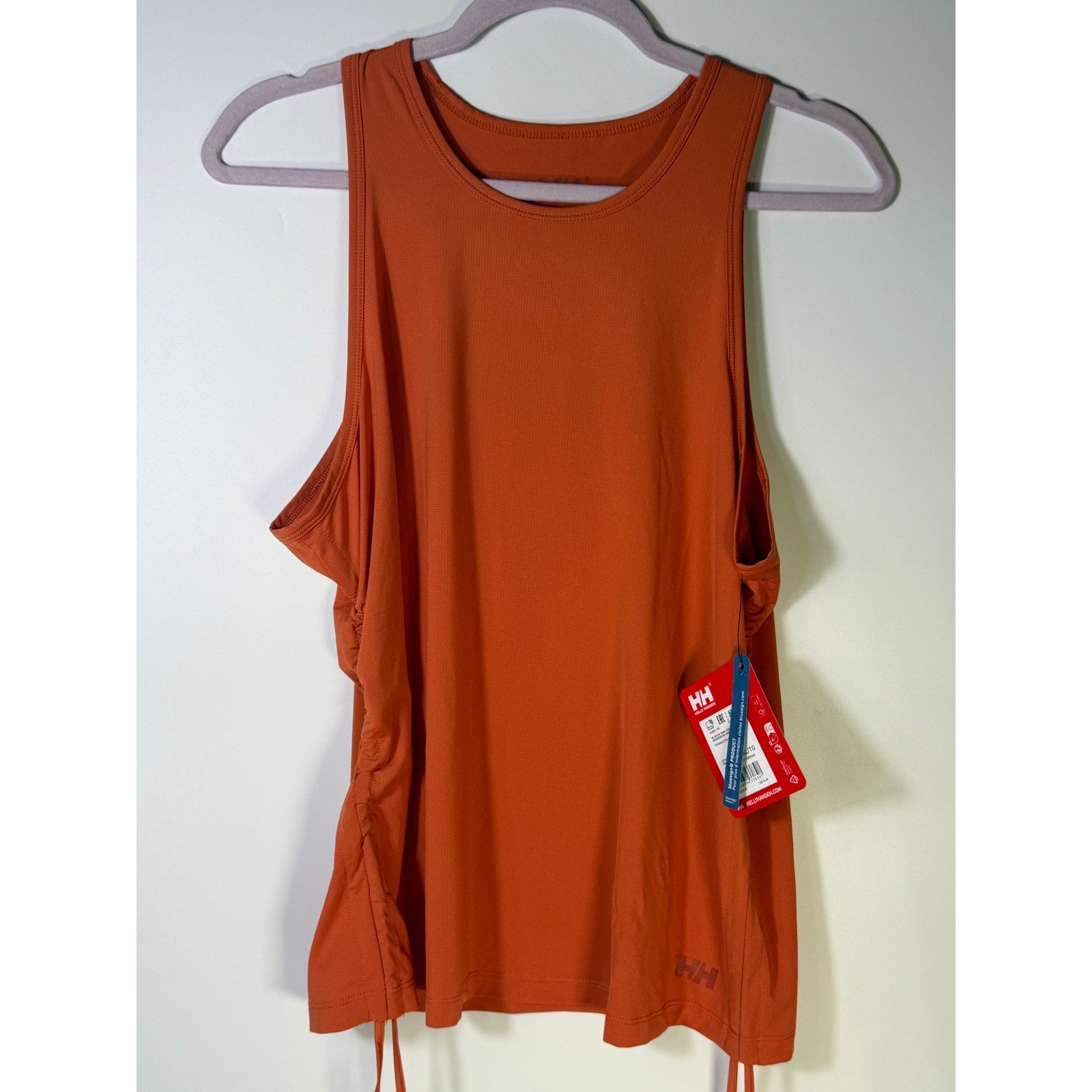 Helly Hansen women's orange active tank top, sleeveless sports bra with drawstring hem, size XL for workout comfort.