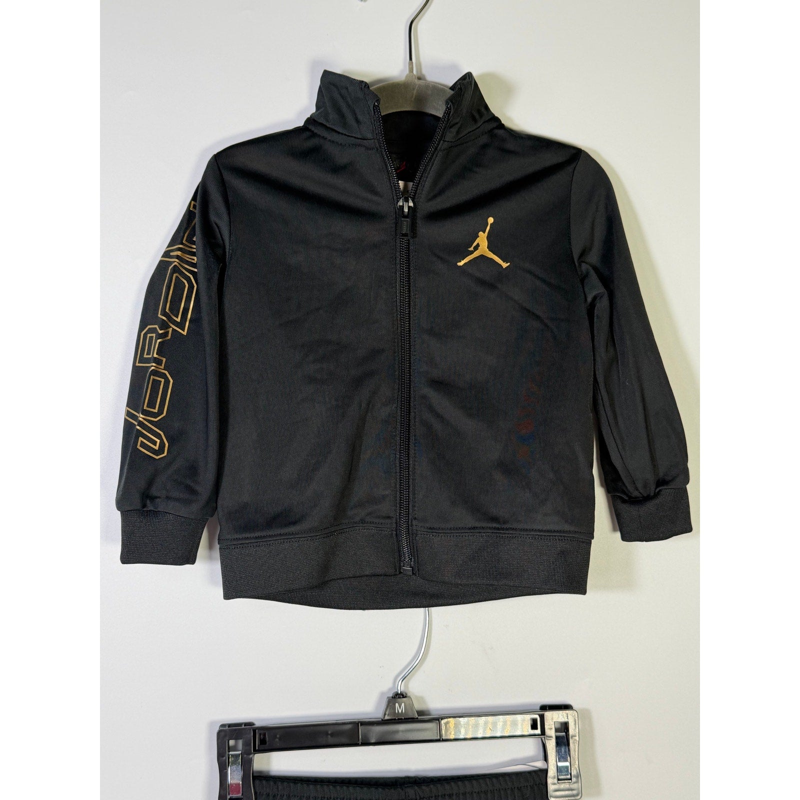 Jordan baby boys black and gold 2-piece track jacket and jogger set, size 18 months, new with tags, casual athletic clothing.