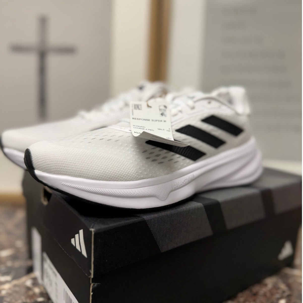 Adidas Response Super women's running sneakers in white, black, and silver with breathable mesh design and cushioned soles.