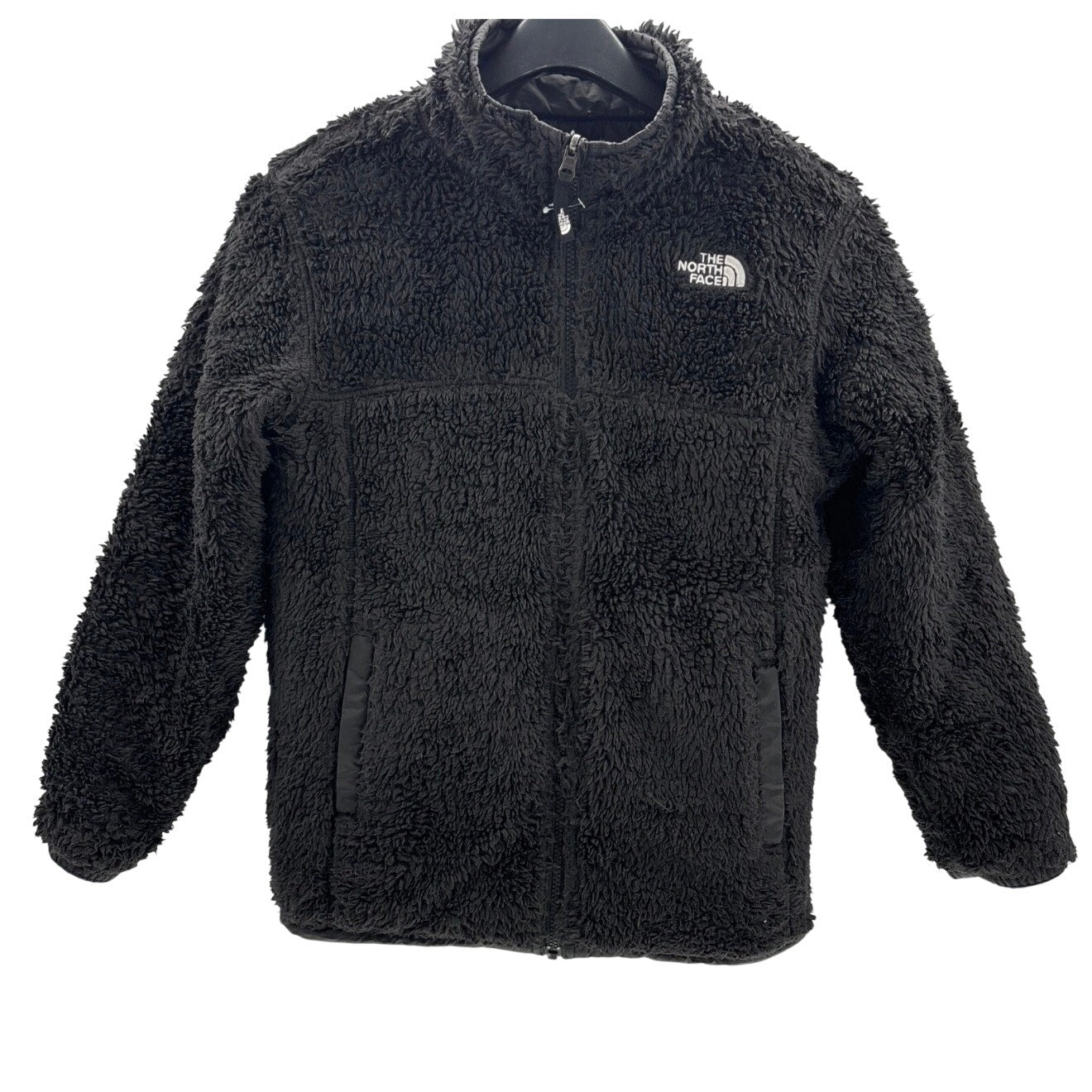 The North Face boys' reversible Mount Chimborazo puffer jacket in blue and black with fleece lining, size large, displayed hanging.