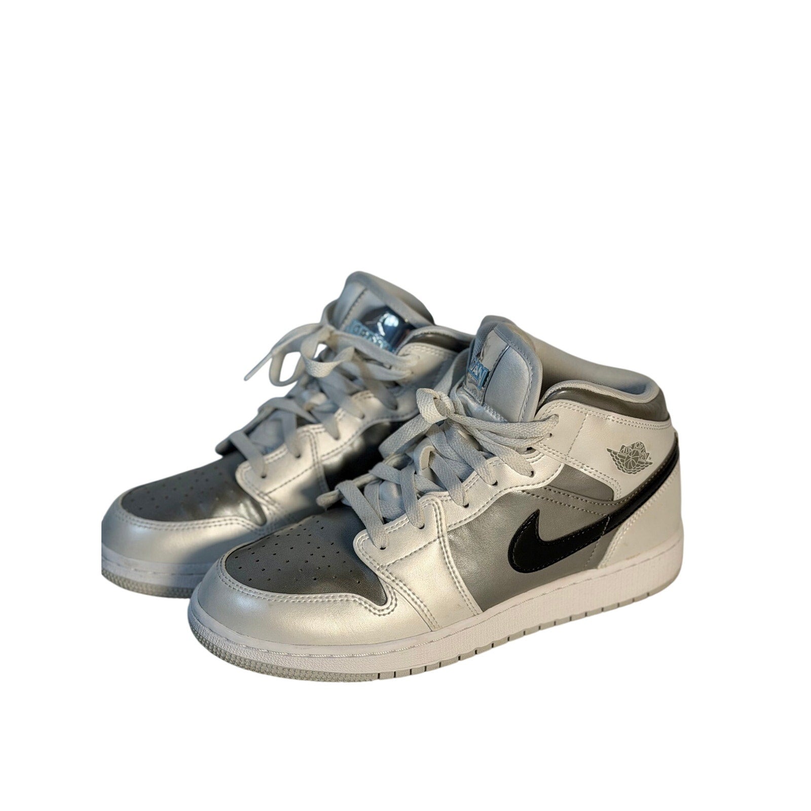 Air Jordan 1 Mid GS sneakers in white, gray, and black for youth size 7Y, featuring classic Jordan design and style.