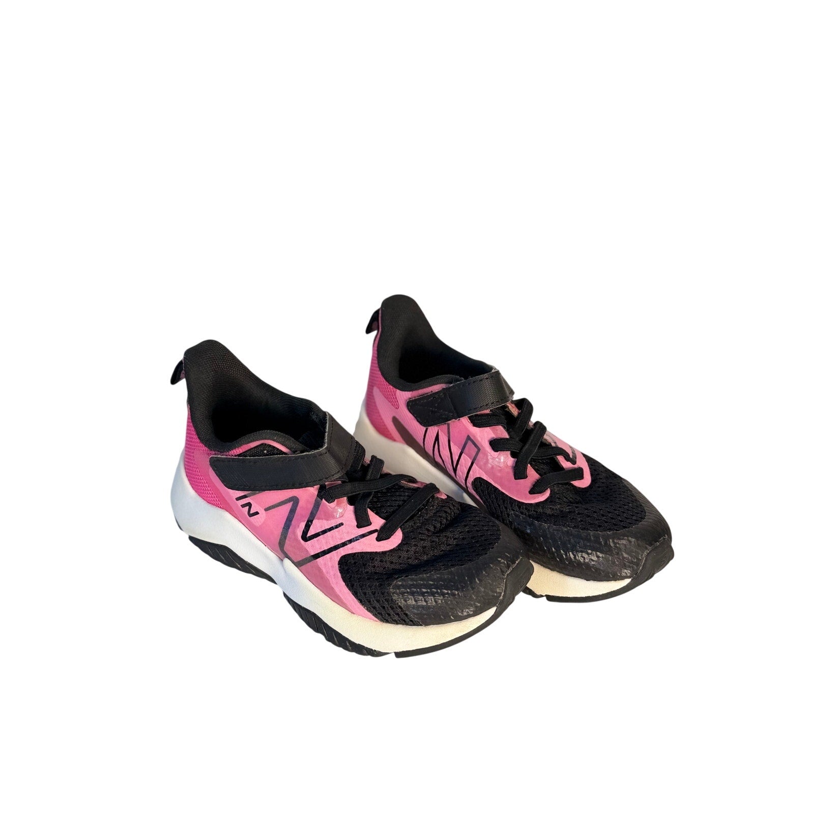 Black and pink New Balance kids' athletic running shoes with hook-and-loop straps, size 11 US.