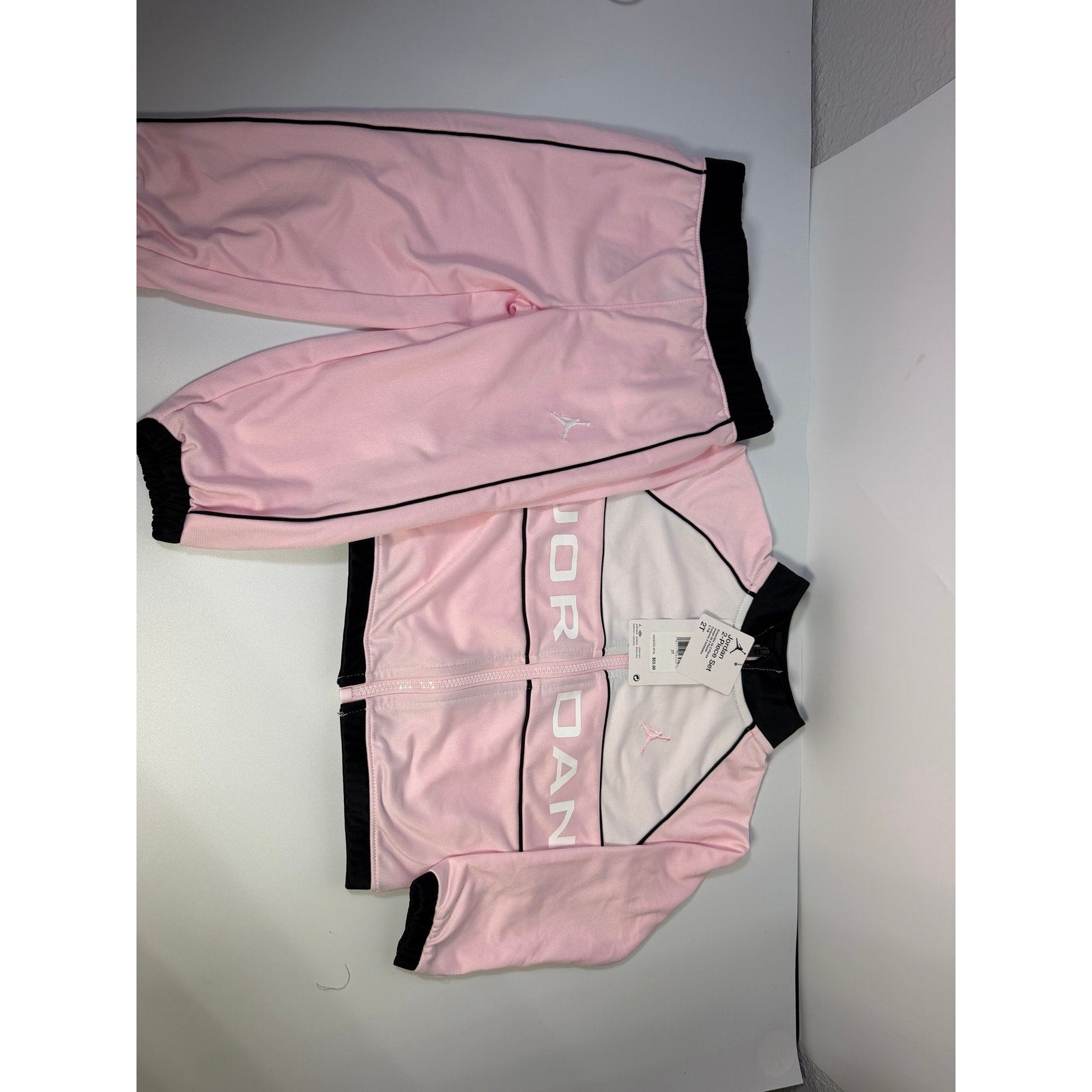 Jordan toddler girls pink and black 2-piece track jacket and pants set, size 2T, new with tags, casual sportswear for kids.