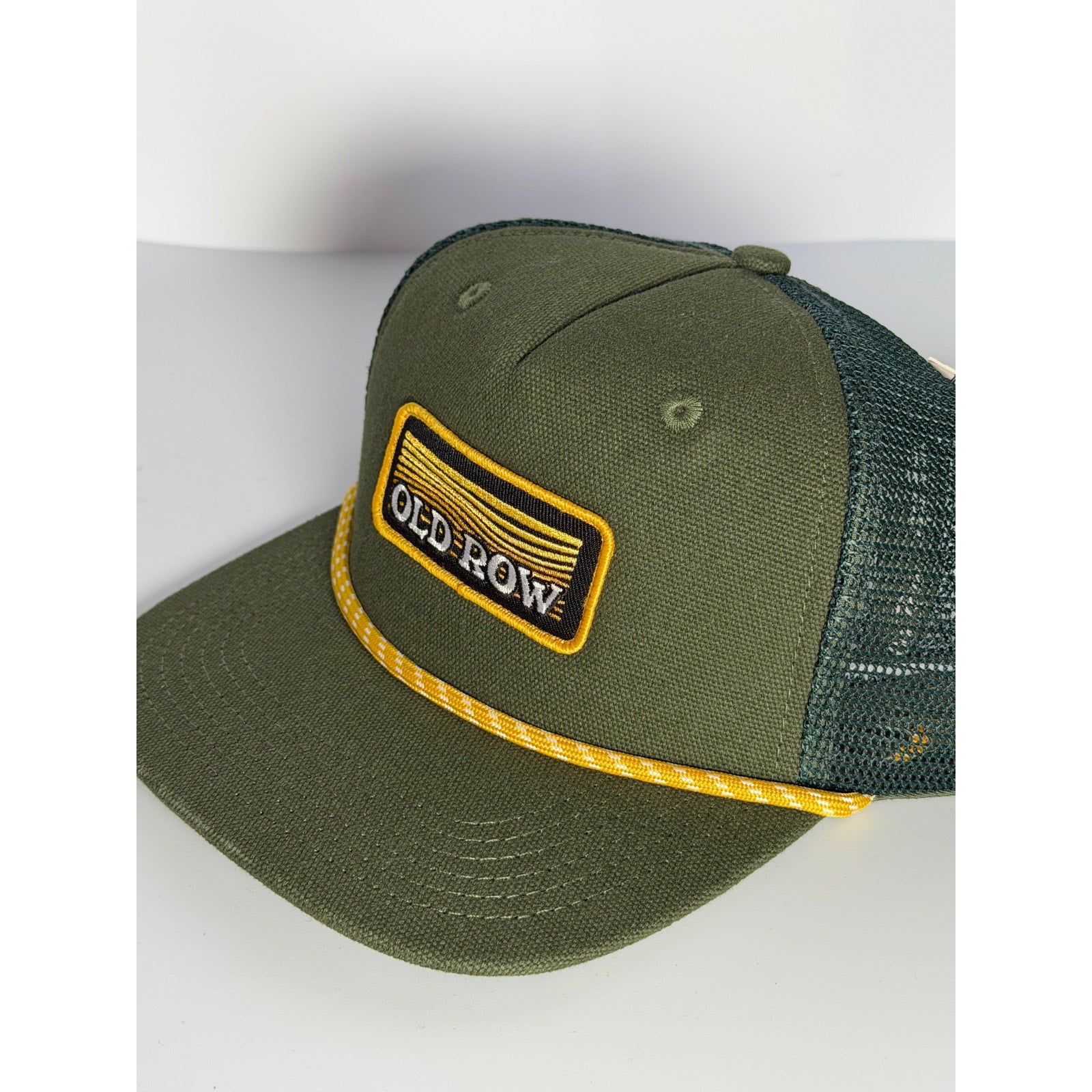 Old Row olive green rope trucker snapback hat with adjustable strap, featuring a classic style and logo design.