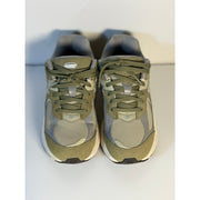 Pre-owned New Balance 2002R athletic sneakers for youth, olive and gray color, size 5.5, showing side view of the shoes.