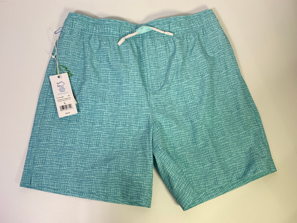 Southern Tide printed teal performance swim trunks laid flat, showing the vibrant pattern and adjustable waistband.