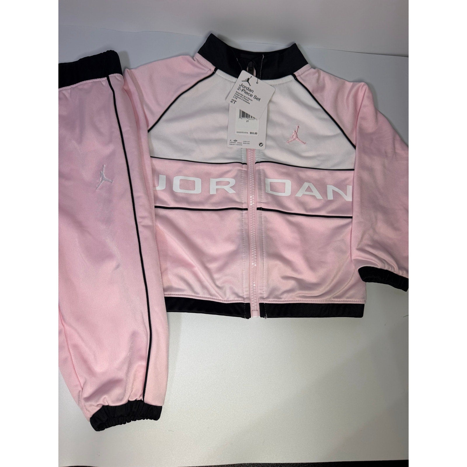 Jordan toddler girls pink and black 2-piece track jacket and pants set, size 2T, new with tags, casual athletic clothing.