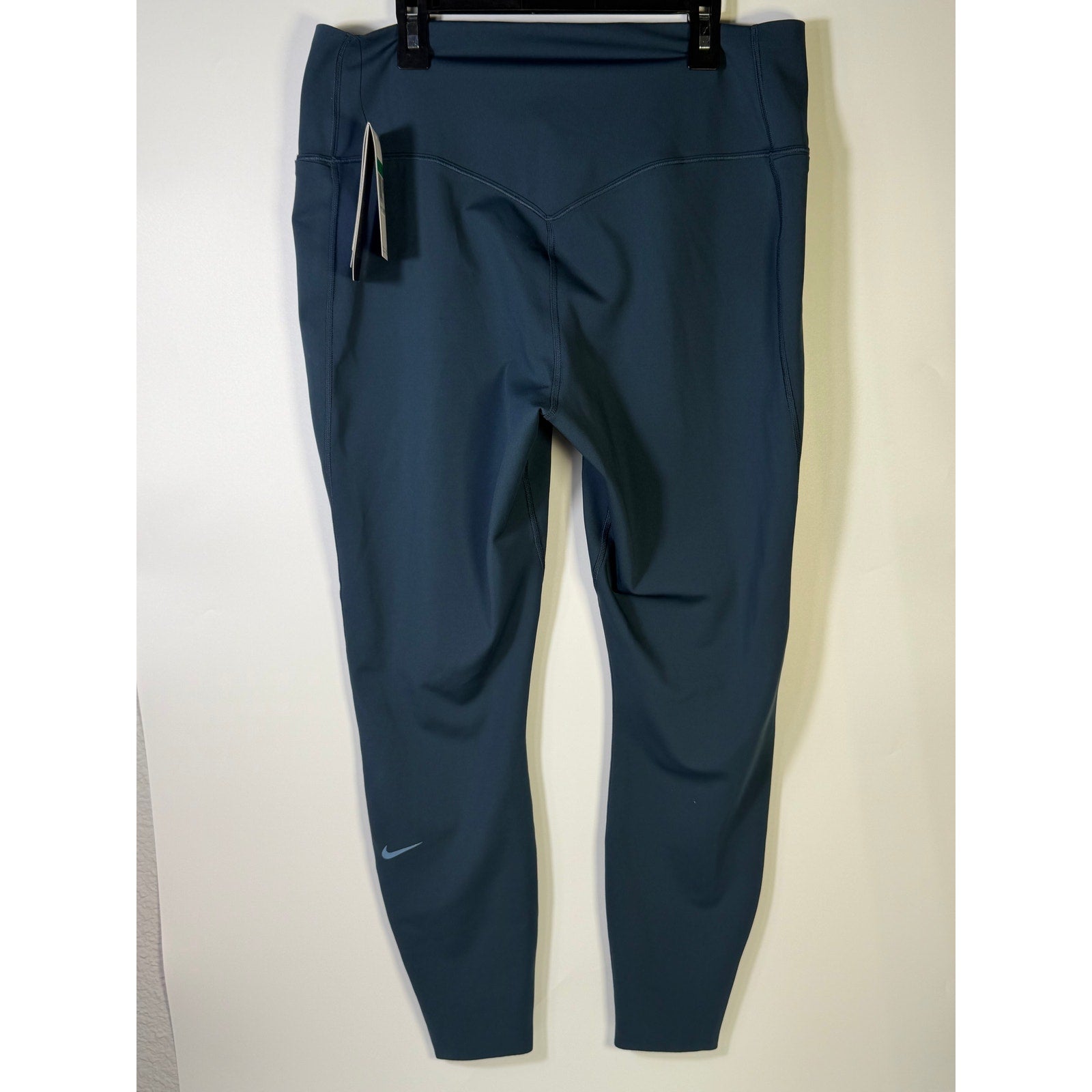 Nike women's blue high-waisted training leggings in size XL, shown flat with waistband and full-length fit.