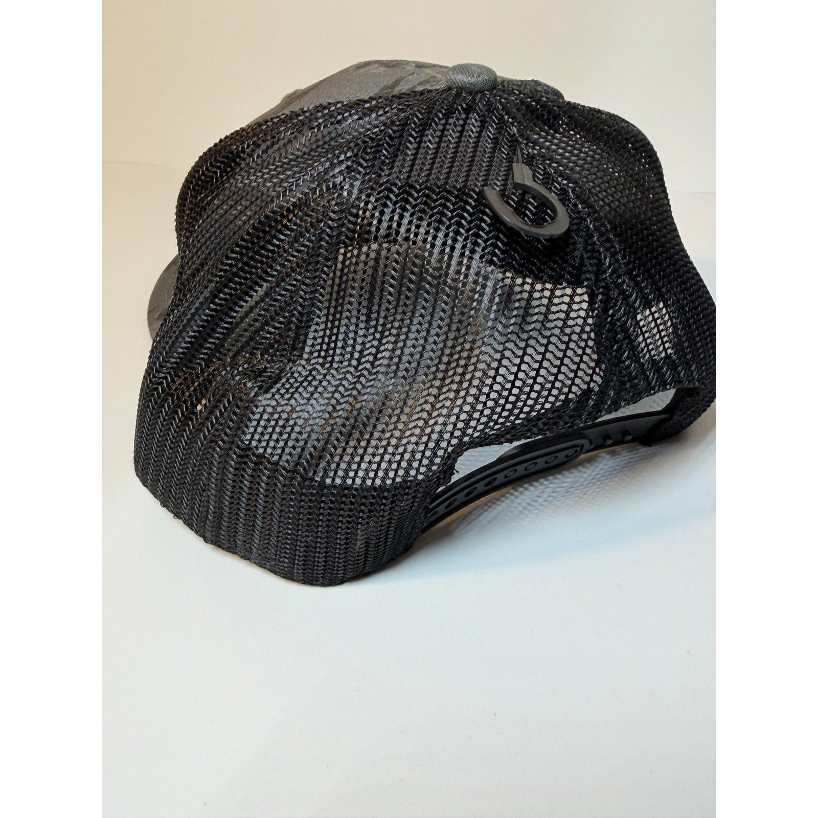 Gray and black 47 Brand Colorado Rockies trucker hat with floral design, adjustable snapback, featuring team logo on front.