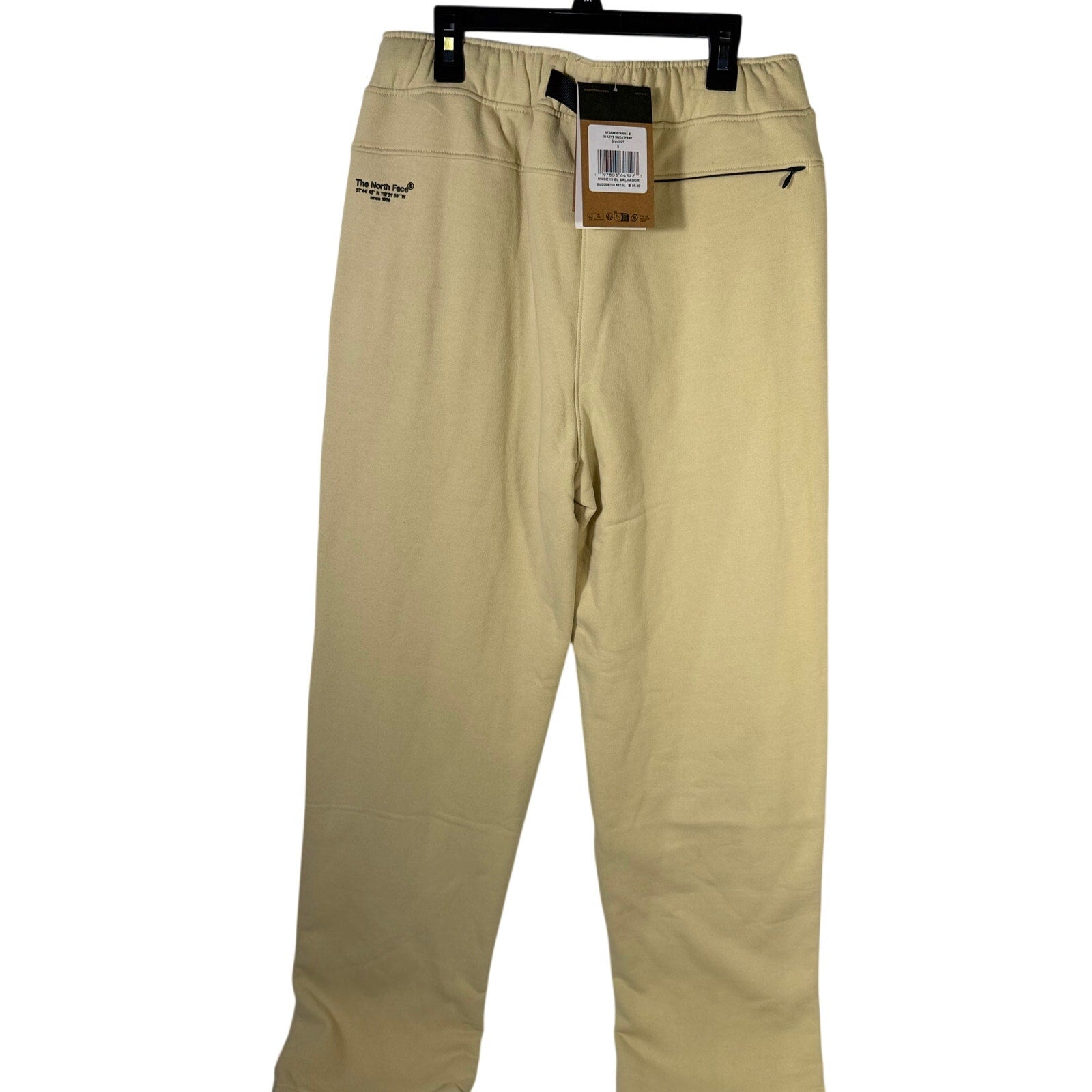 The North Face men's AXYS sweatpants in gravel beige, size small, shown laid flat with elastic waistband and tapered fit.